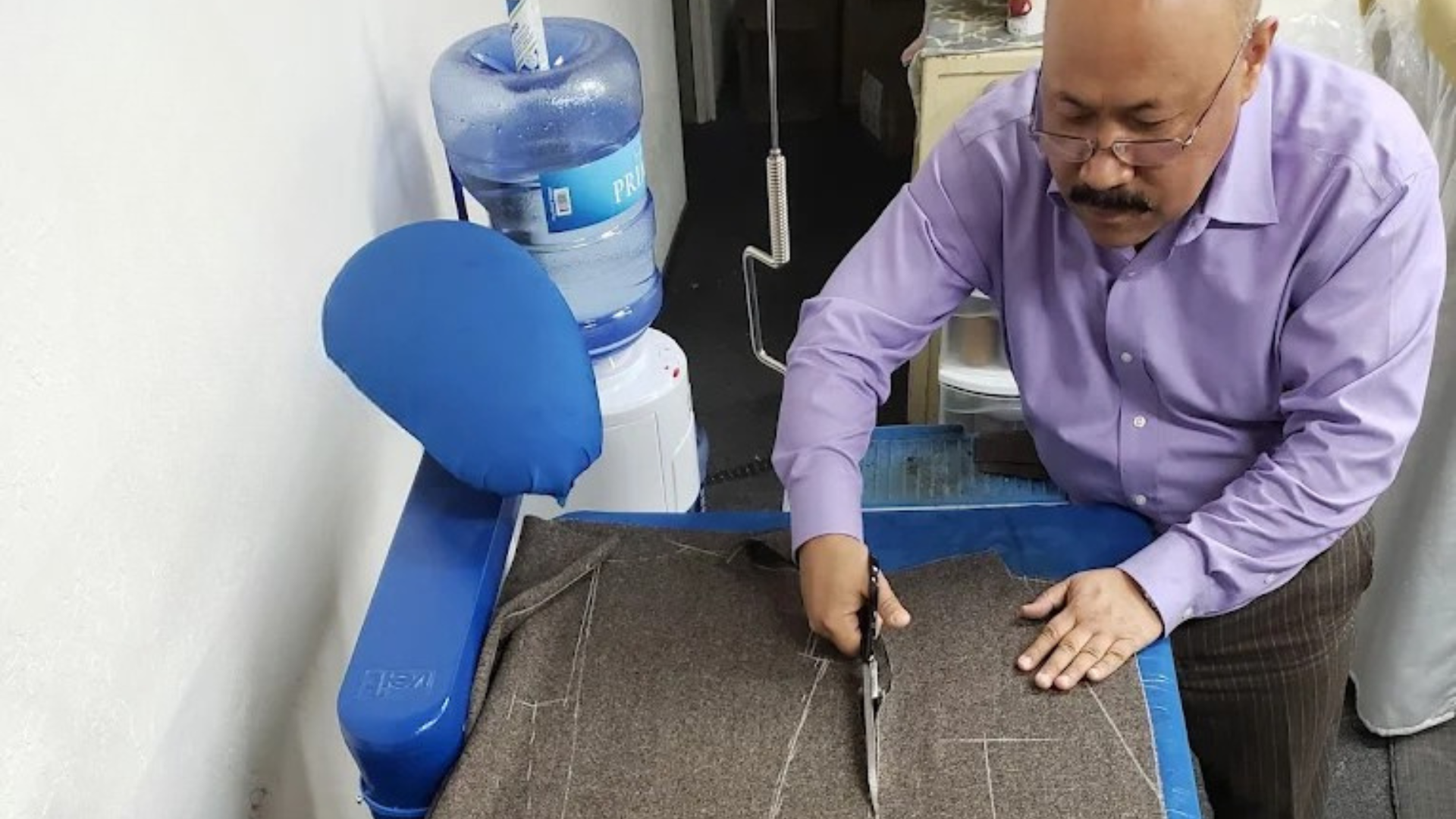 Skilled tailor working on fabric with precision and expertise