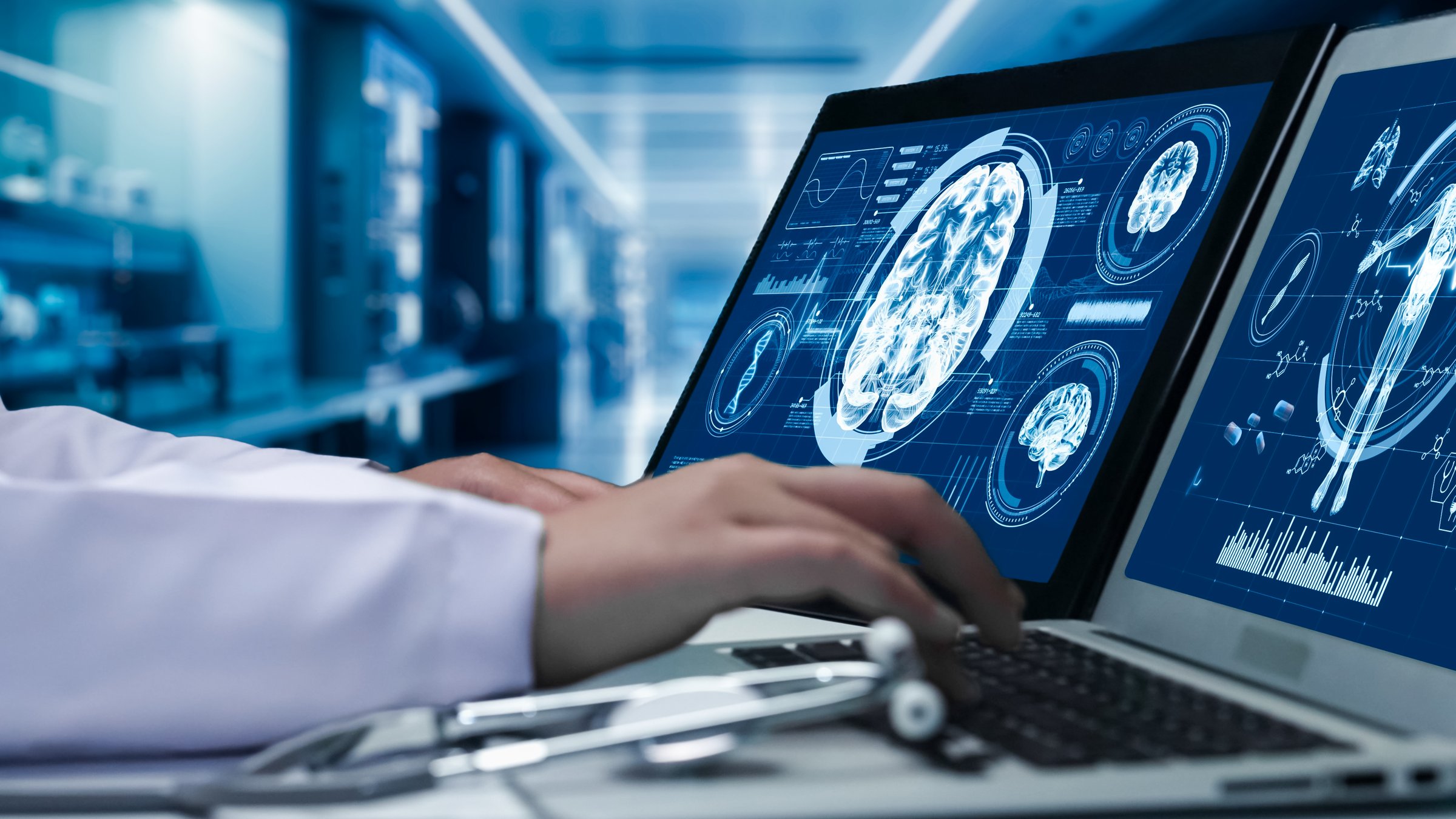 Close up of doctor working on tablet and laptop with human brain anatomy display on screen. Smart medical worker checking hand and diagnosis brain injury while preparing for brain surgery. Remedial.