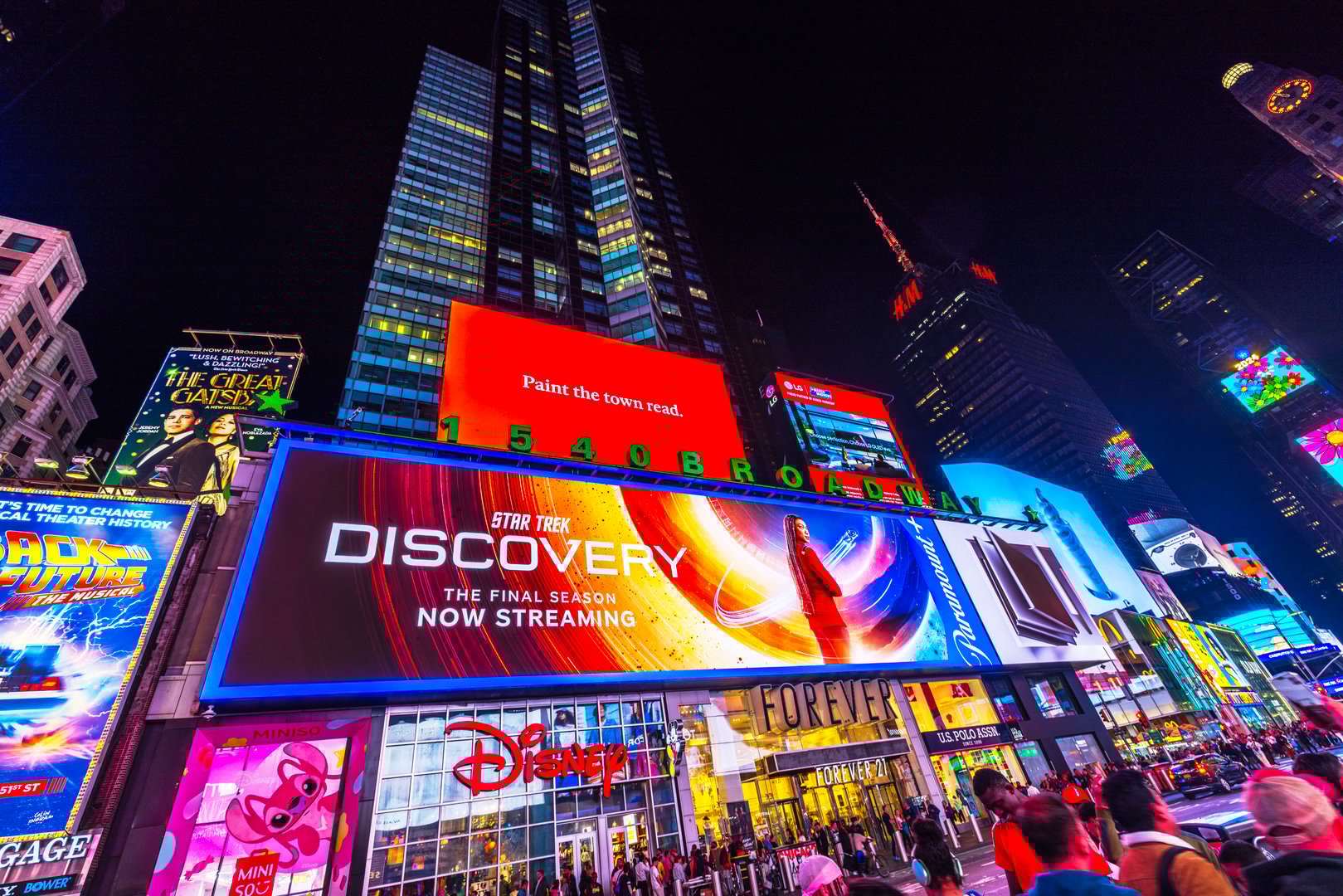 New York. USA. 09.22.2024. Times Square at night featuring billboards for 'Star Trek Discovery,' 'The Great Gatsby,' and 'Back to the Future' musicals in New York City.