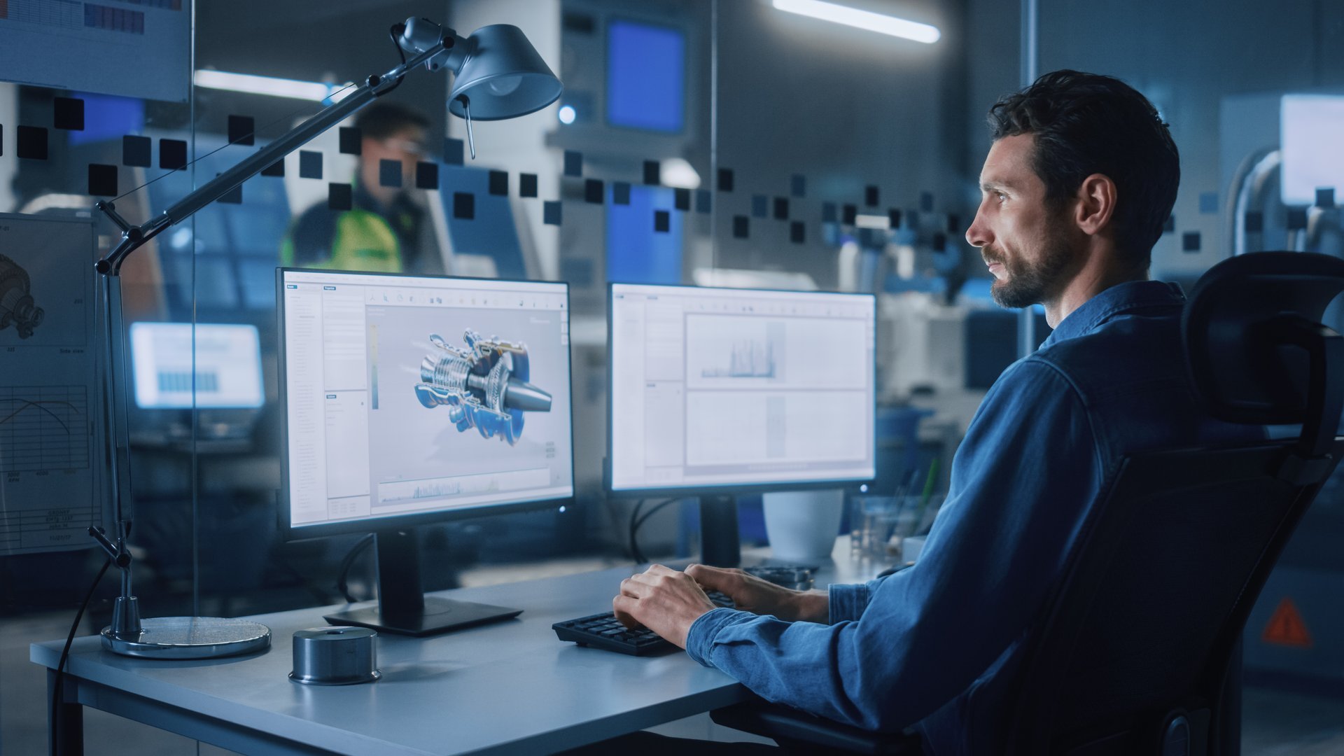 Industrial Engineer Solving Problems, Working on a Personal Computer, Two Monitor Screens Show CAD Software with 3D Prototype of Eco-Friendly Electric Engine Concept.