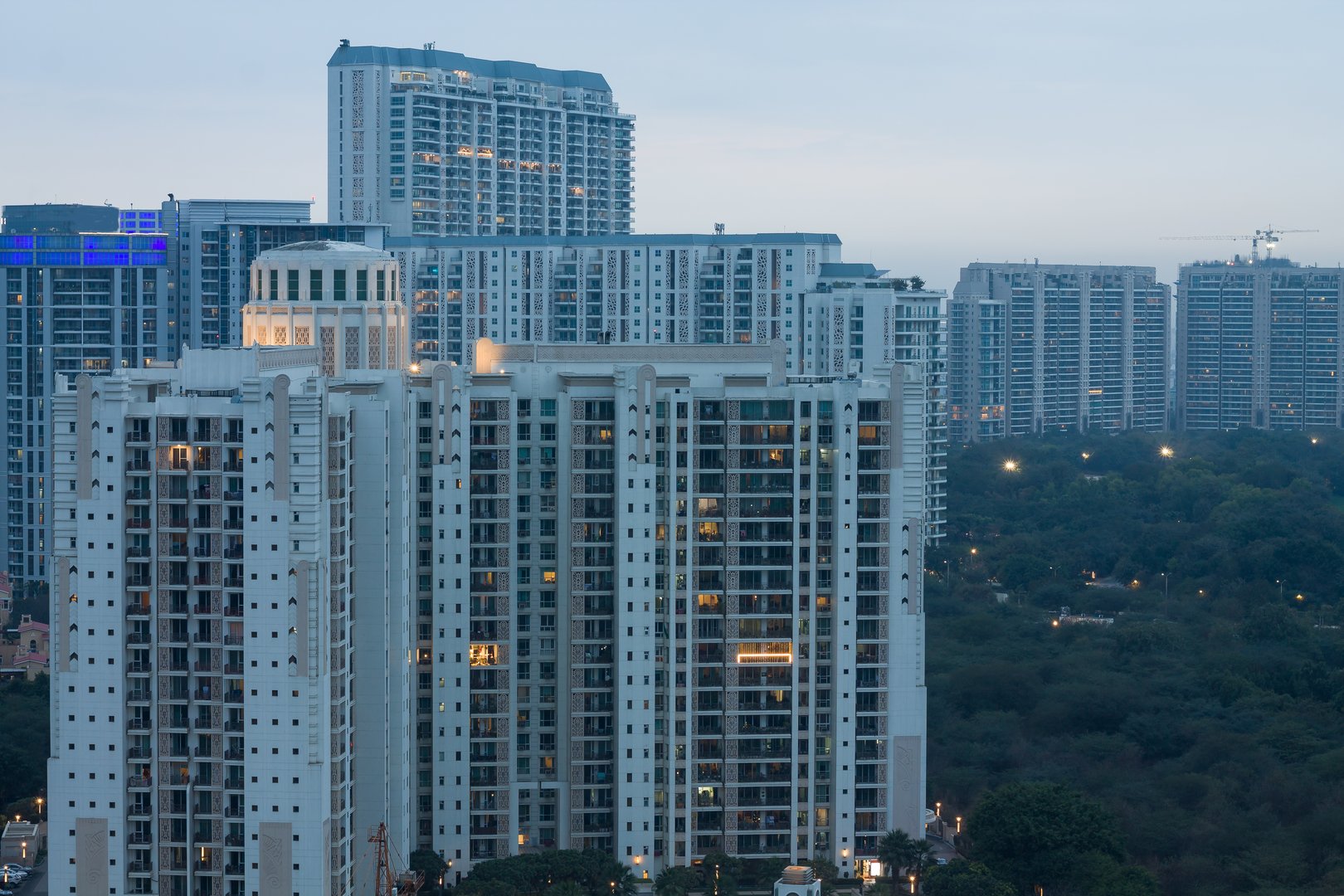 Gurgaon,Haryana,India colorful sunset on a foggy winter evening.Aerial view of Gurugram urban cityscape with modern architecture,commercial,luxury residential apartment buildings.Delhi NCR.