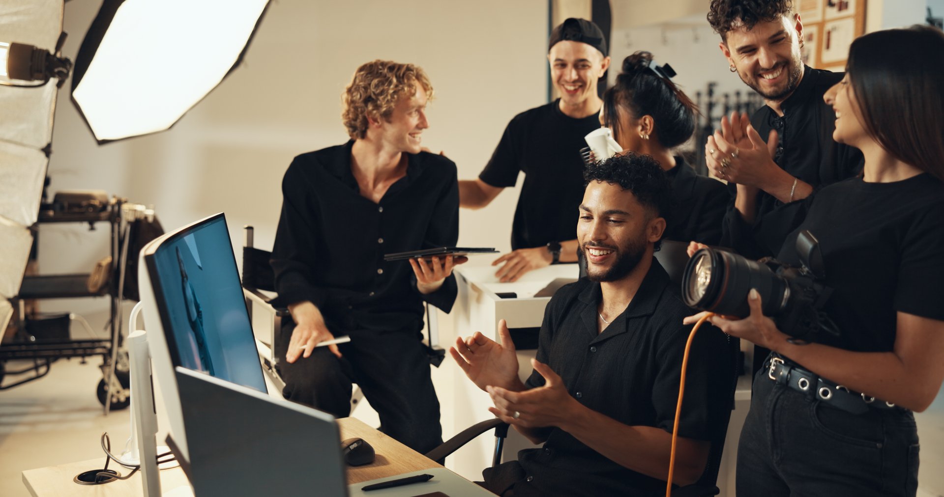 Happy, people or clapping for photography success for production results, project or review. Teamwork, producer or computer to check for studio photographers, magazine catalog or filming achievement