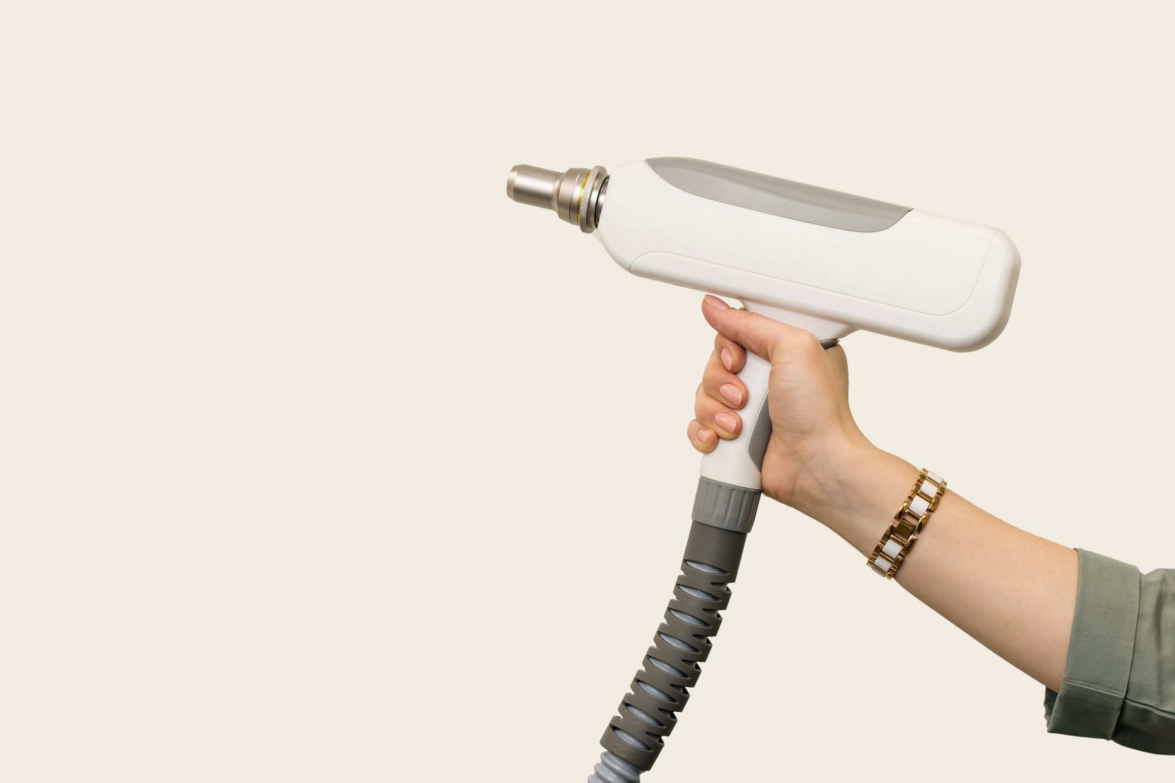 Ð¡osmetician holds hands maniple for carbon peeling and tattoo or permanent makeup removal procedures on light background. Empty space for text. Hardware cosmetology