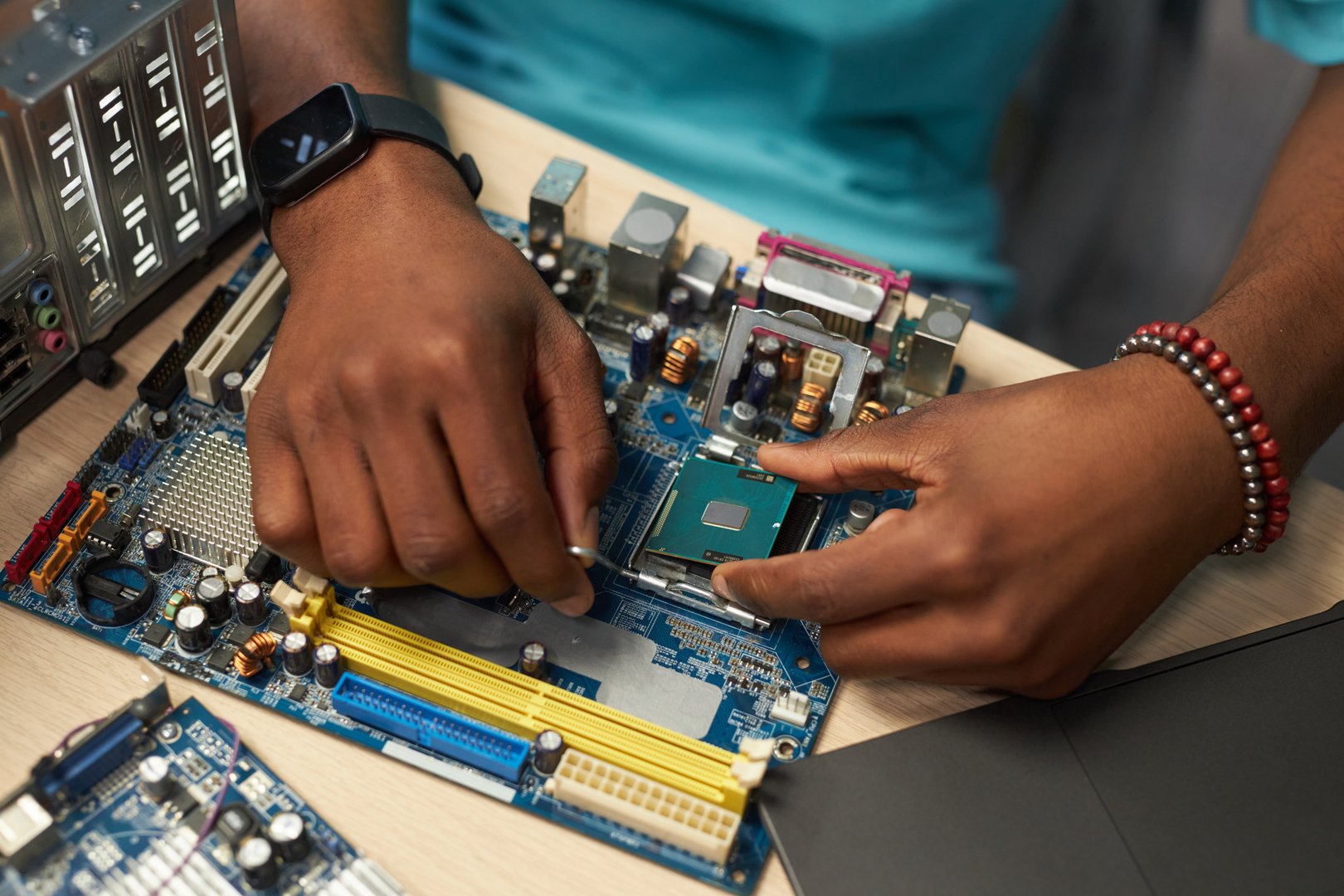 Close-up of repairman working with computer details in workshop