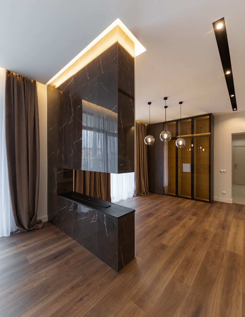 Vertical photo of Interior design spacious bright studio apartment in Scandinavian style and warm pastel white and beige colors. trendy furniture in the living area and modern details in the kitchen area.