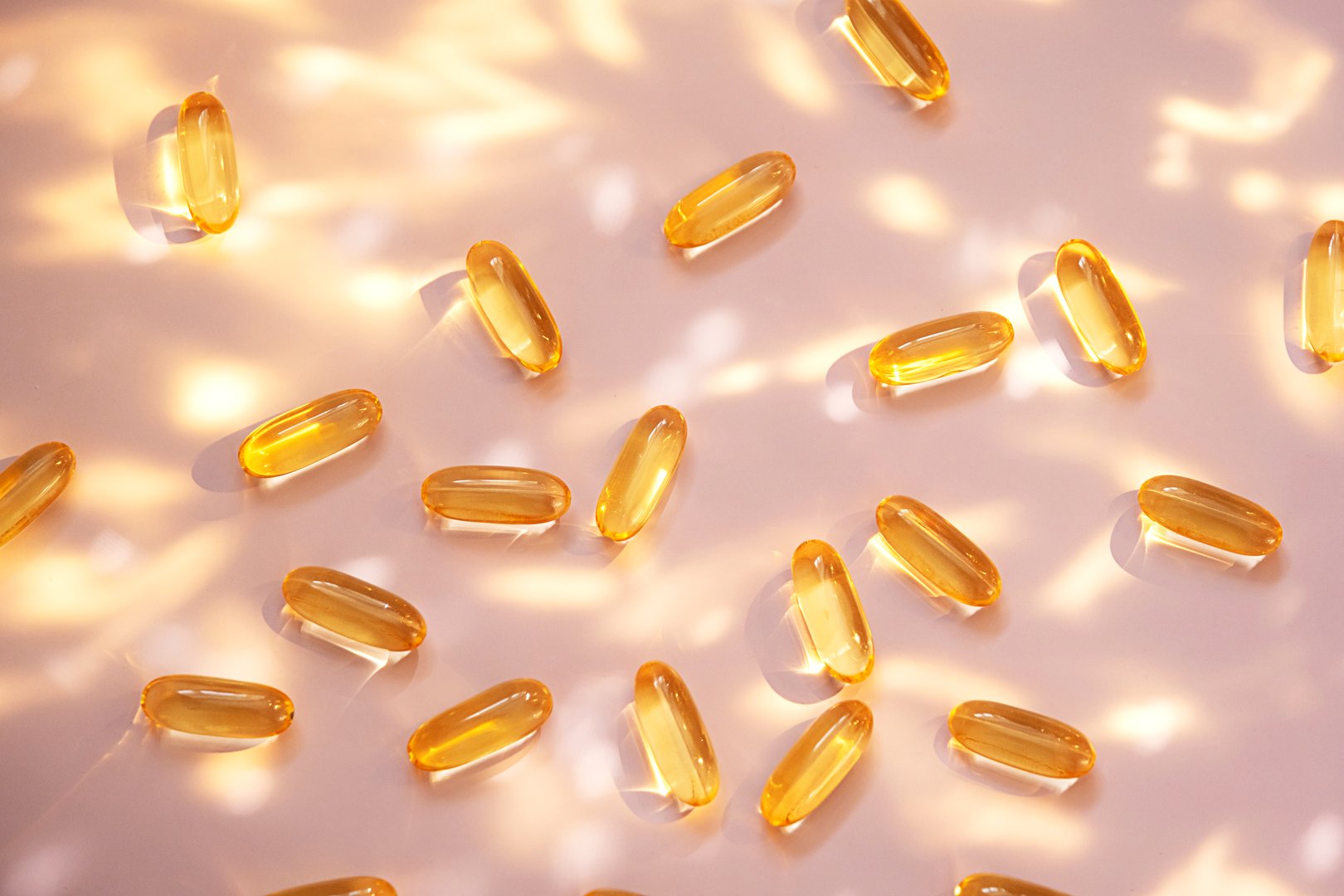 Yellow fish oil capsules representing vitamin D supplements