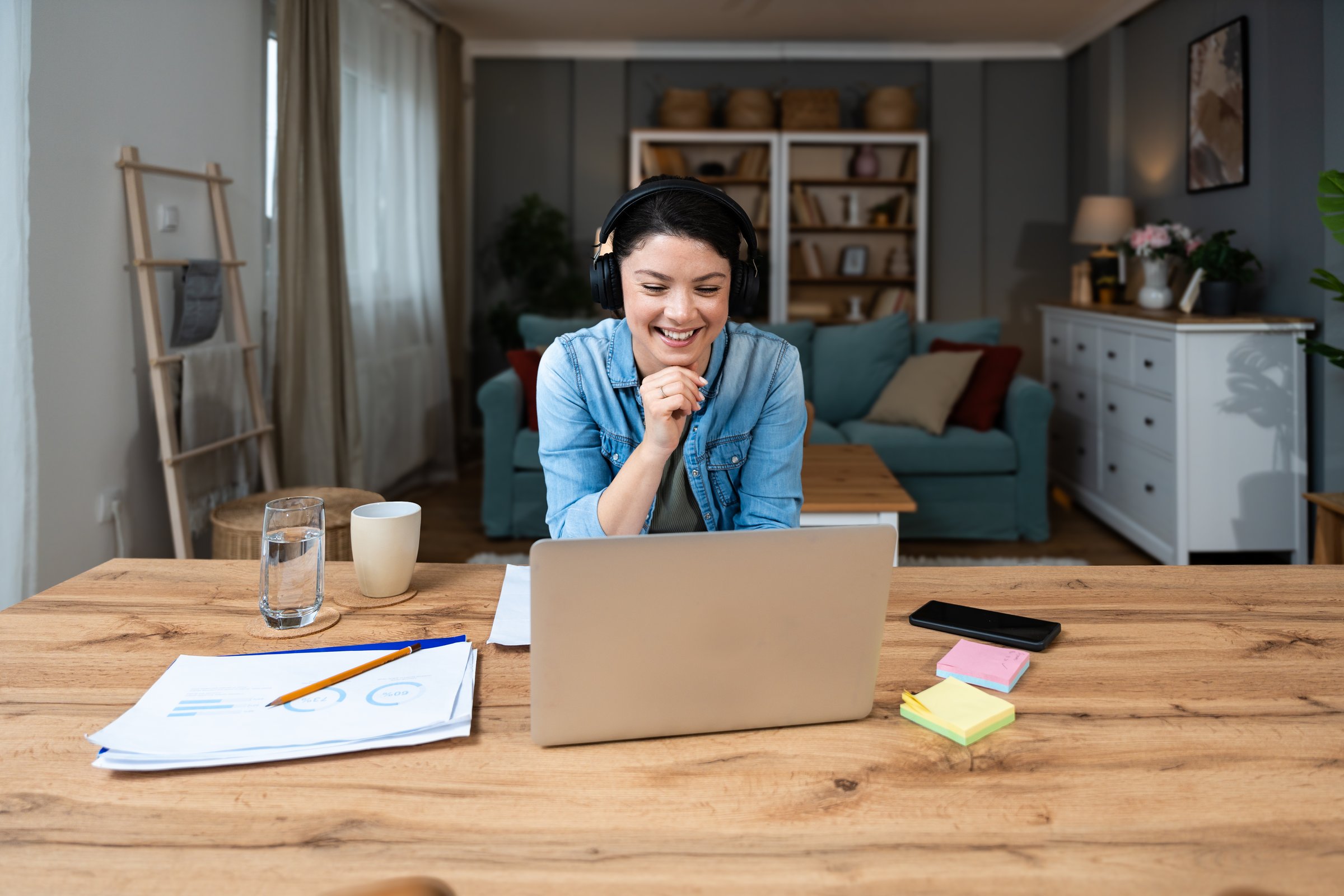 Young freelance businesswoman attending online educational class on laptop computer webcam teleconference in progress watching and listening educator expert about economy and finance. Online business