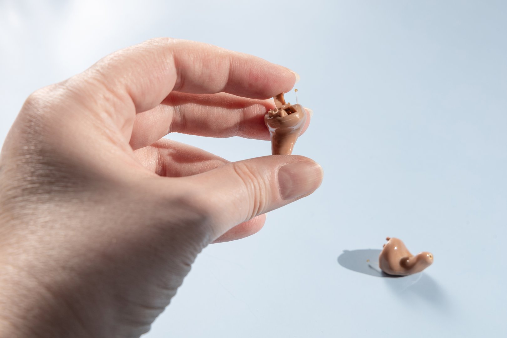 Female hand holding modern hearing aid