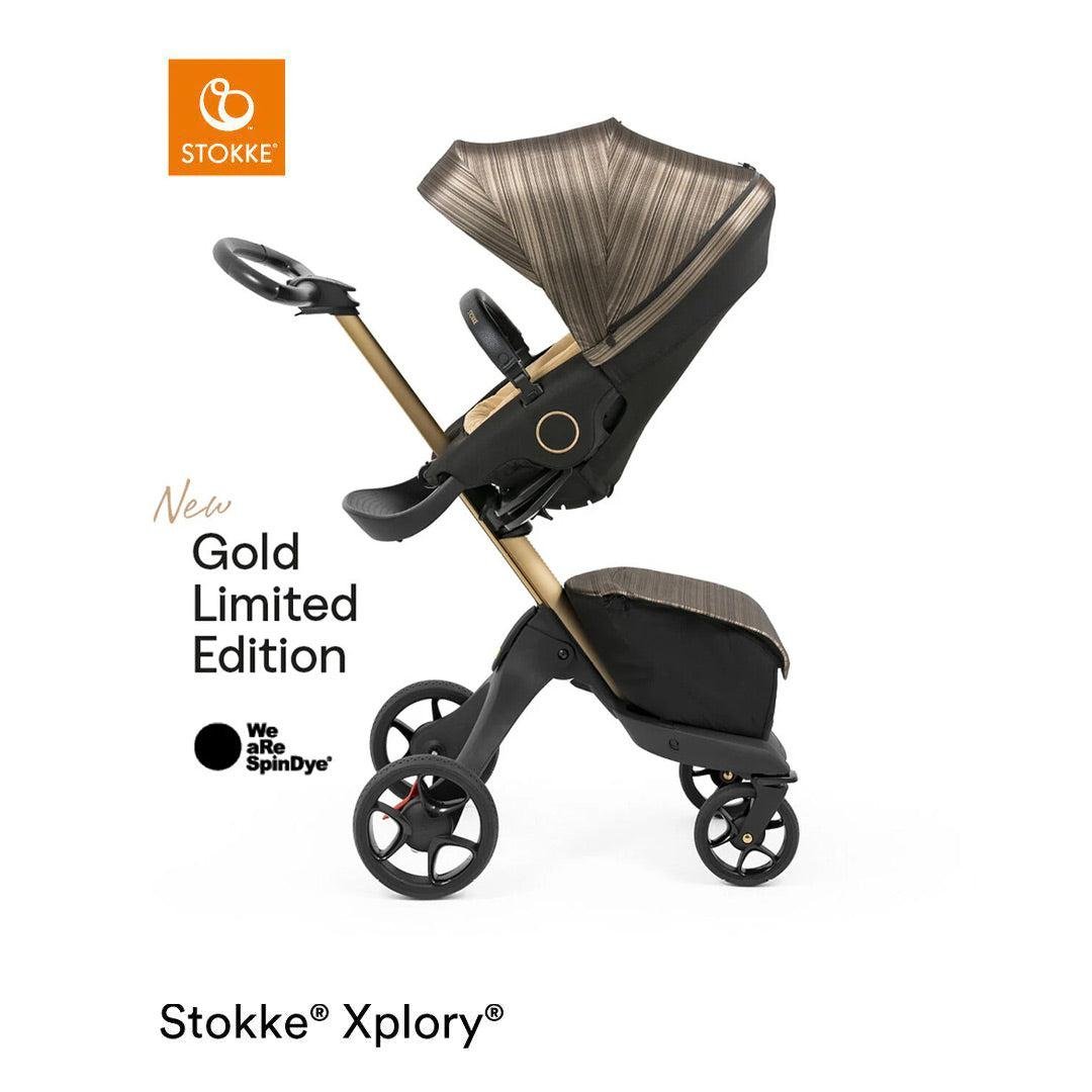 Stokke Xplory stroller in a gold limited edition design with brown and black accents, side view.