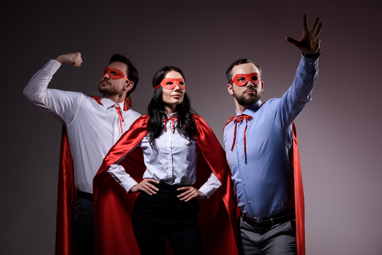 super businesspeople in masks and capes showing superpower isolated on grey