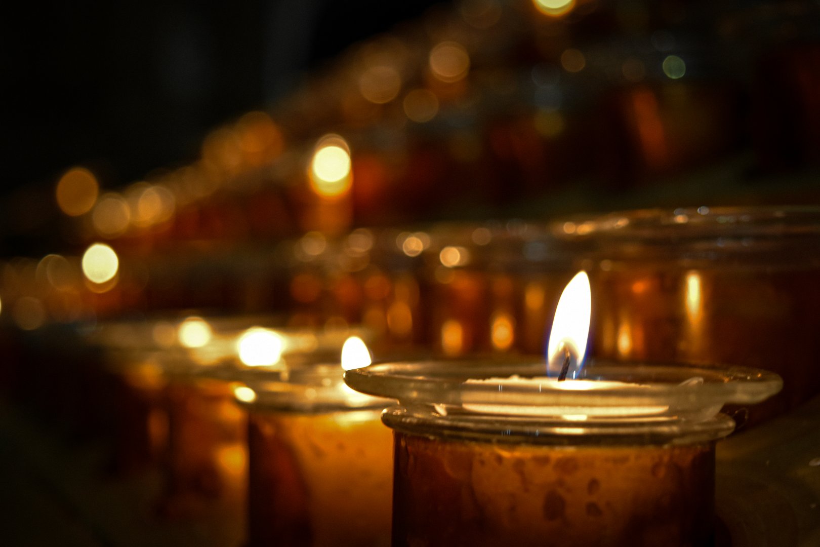 Some lit up candles at a church