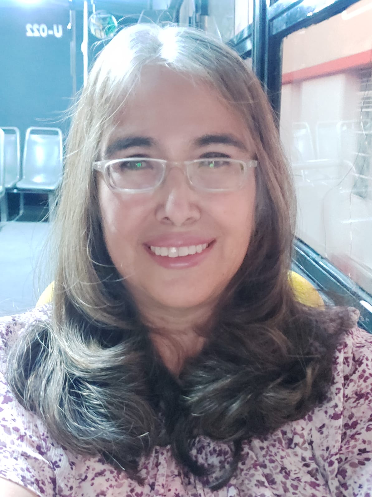 Professional Latin woman with black hair, brown eyes