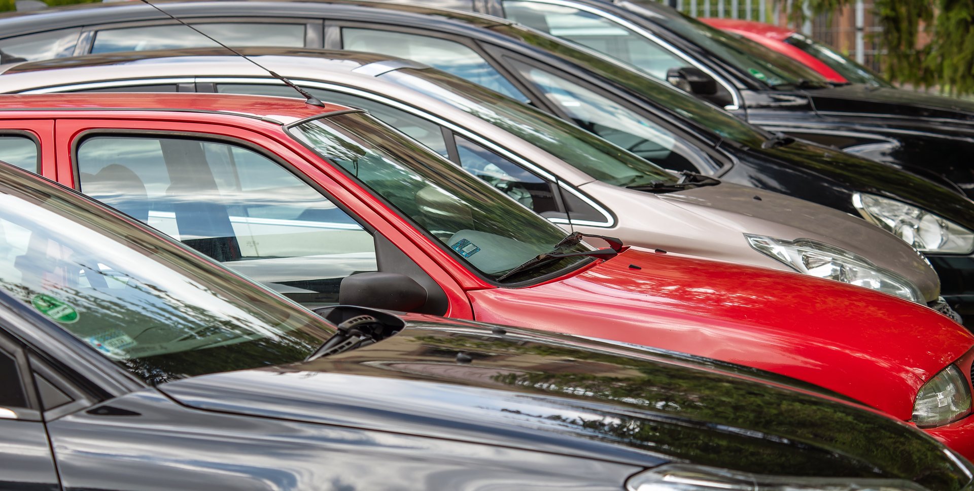 Different colored cars parked next to each other