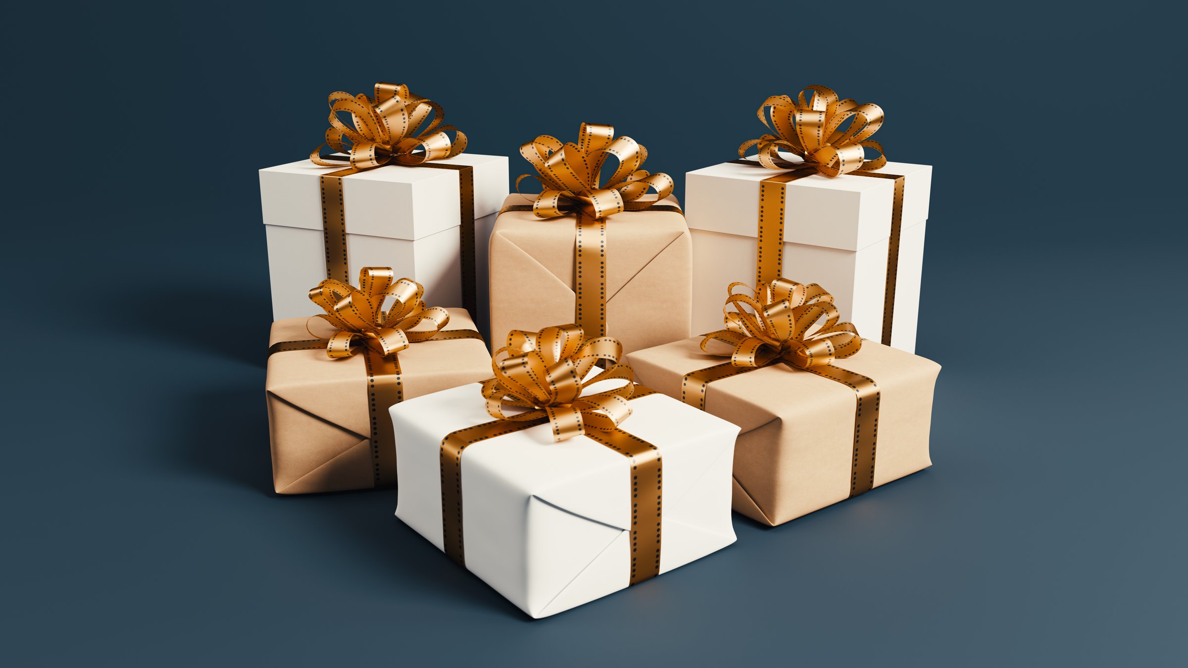 Minimalist Arrangement of Gift Boxes with Golden Ribbons on a Dark Background