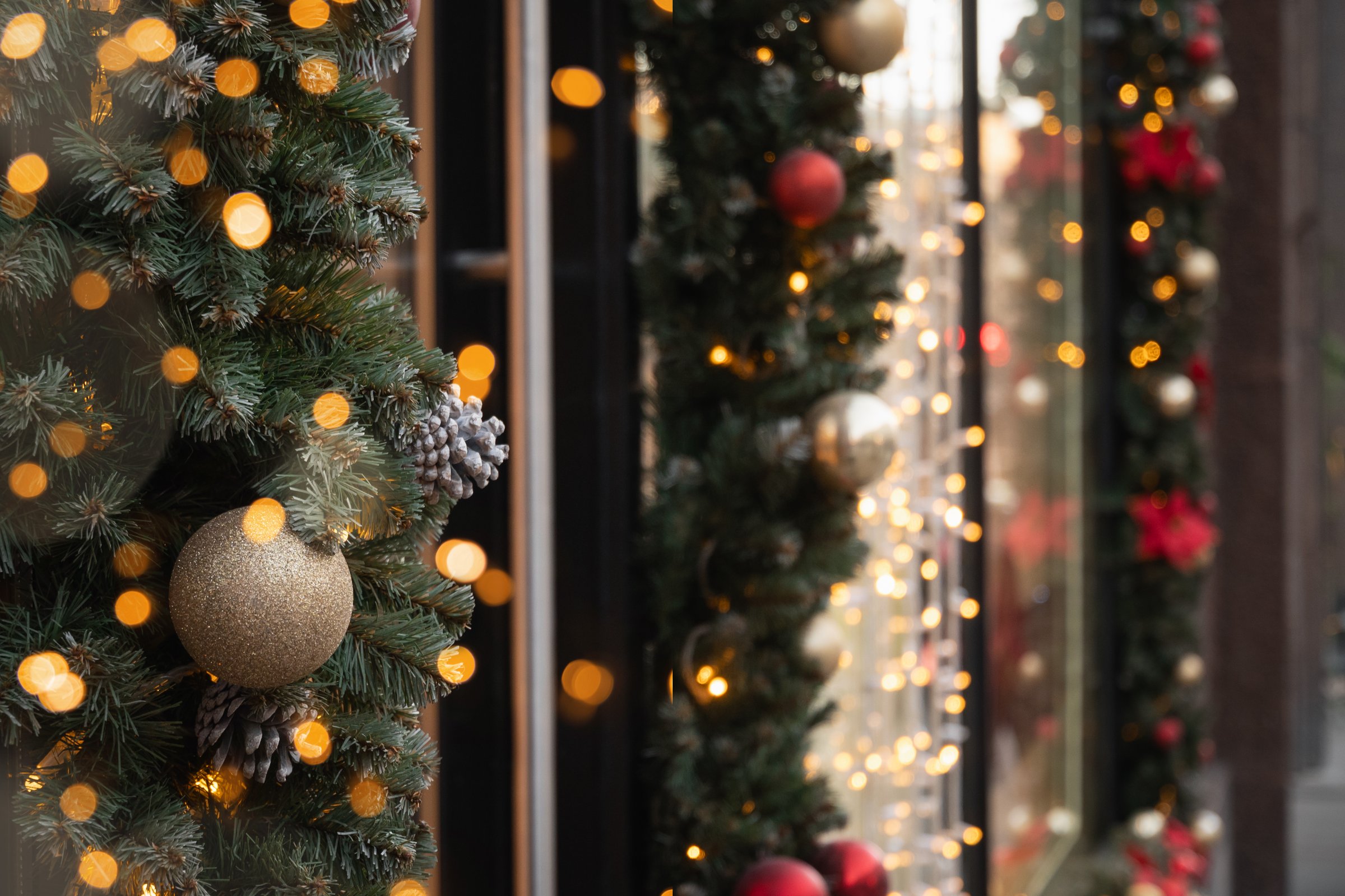 Festive Christmas decorated entrance to luxury store with twinkling lights. Close up. Xmas holiday background.