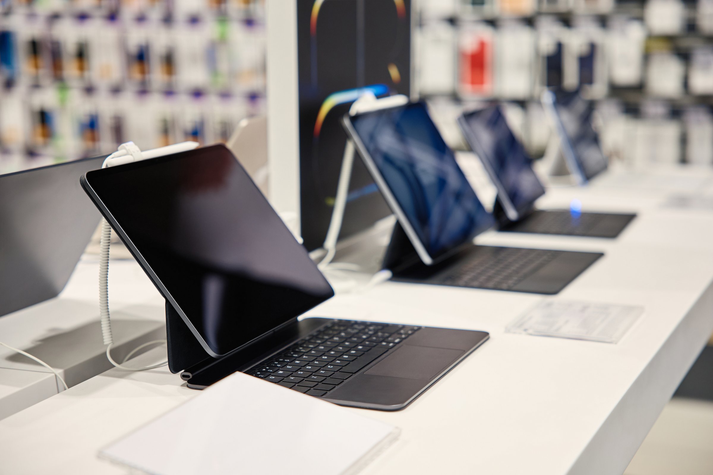 The showcase features sleek, modern tablets paired with stylish keyboards, beautifully displayed in an inviting store for tech enthusiasts and gadget lovers who appreciate innovation and technology