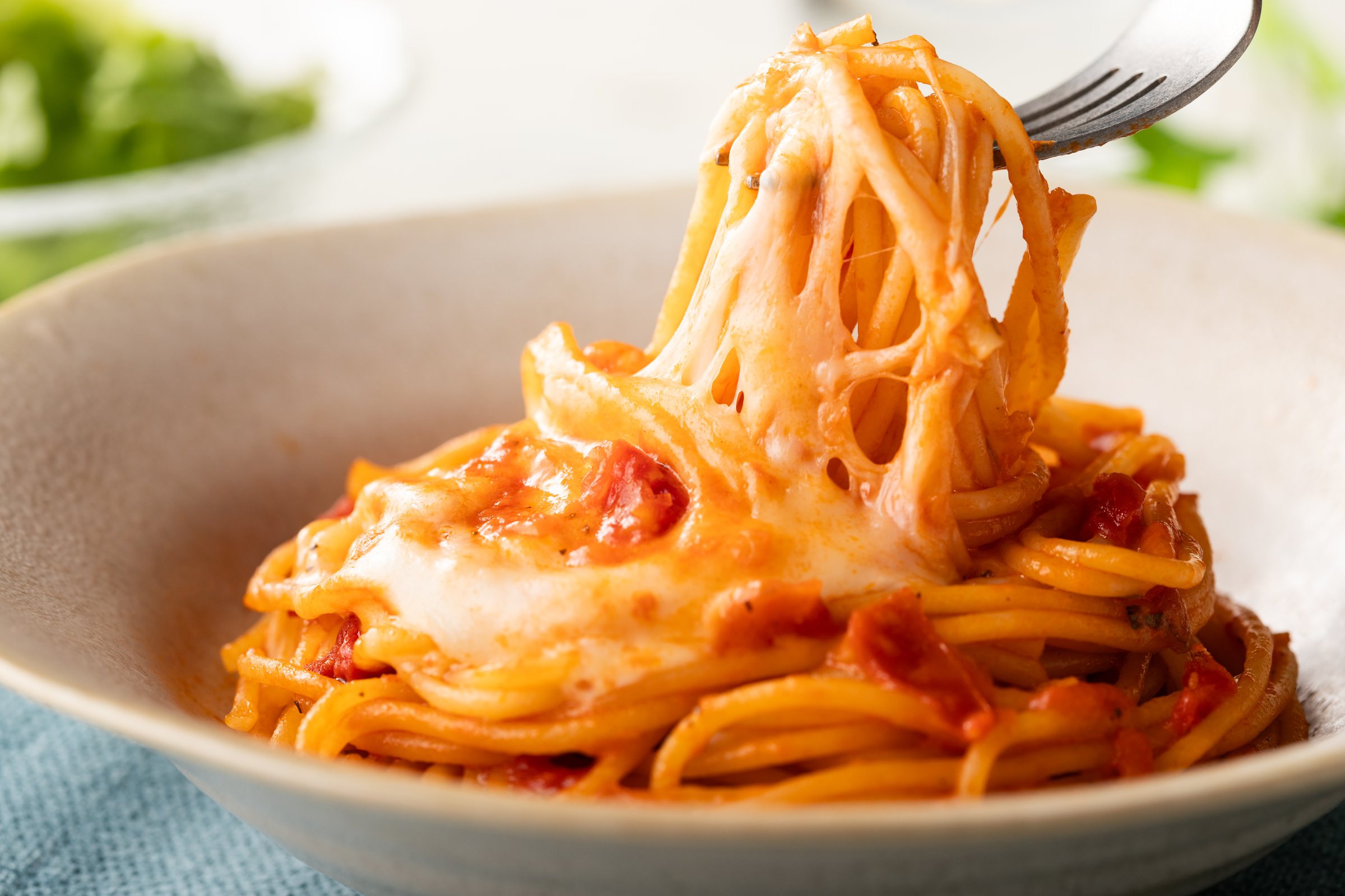 Delicious spaghetti with stringy mozzarella cheese and tomato sauce.