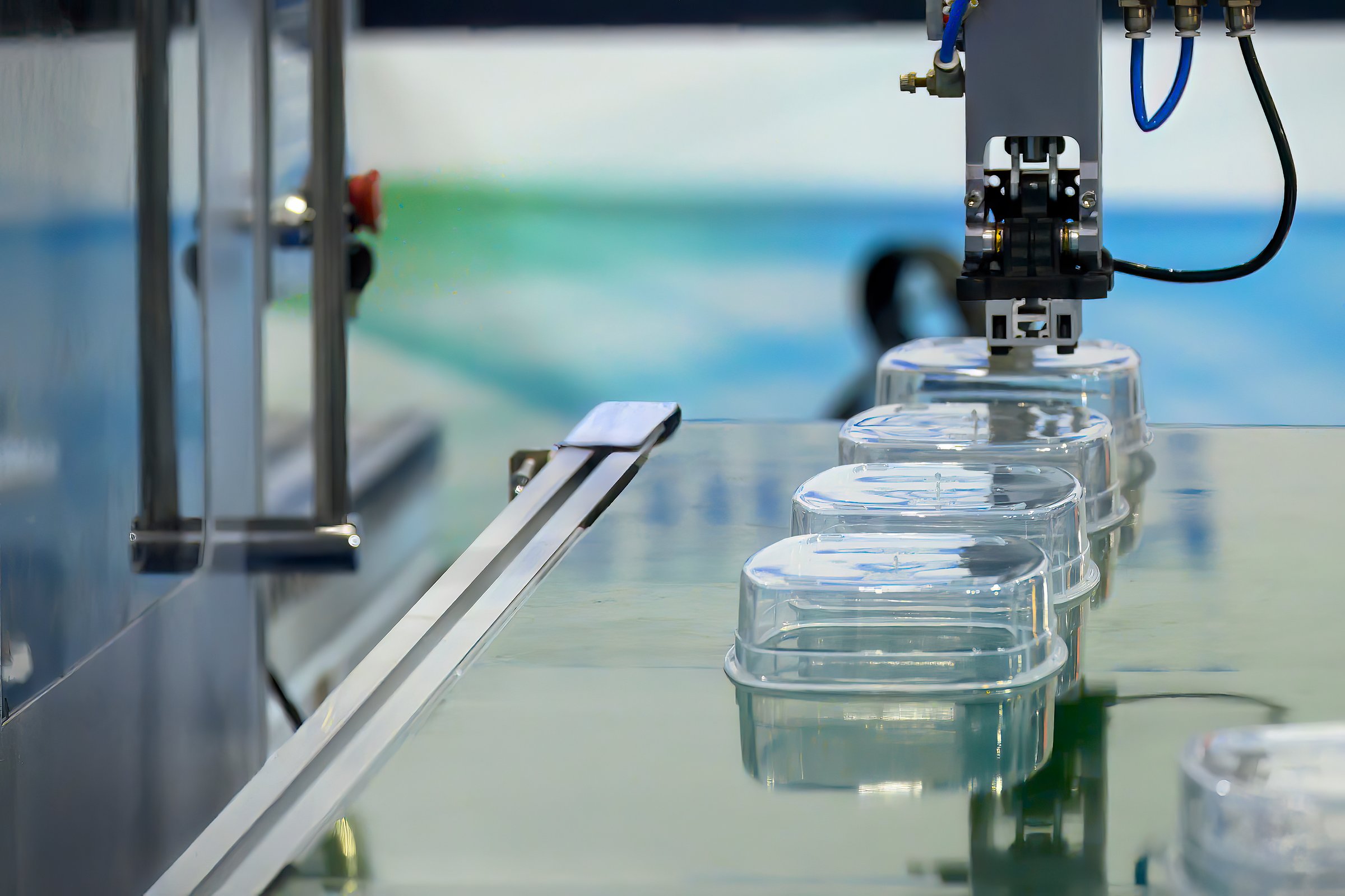 The box container part on the conveyer belt from injection process. The food container box products  from plastic processing.