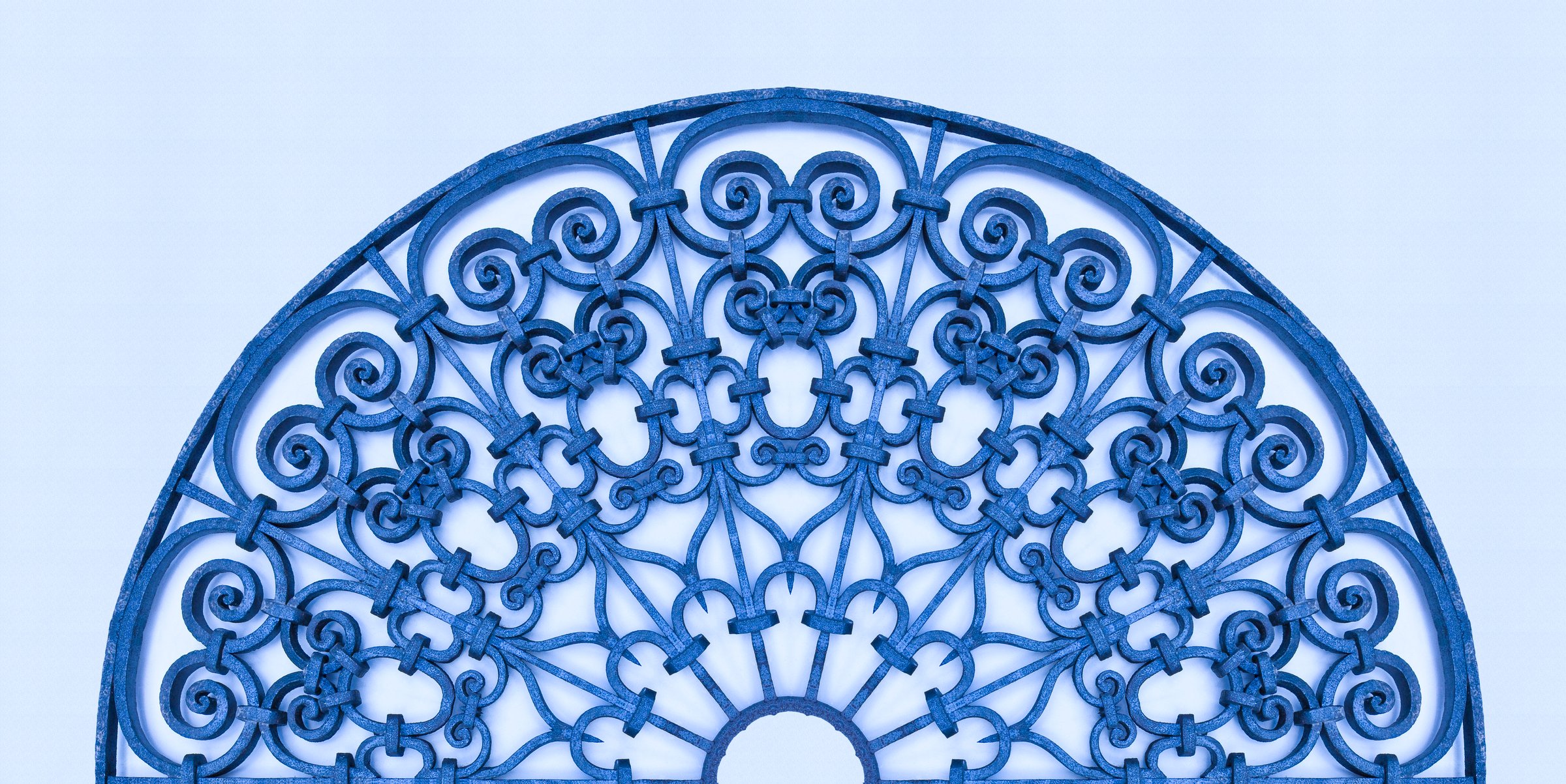 Old italian wrought iron grating with floral decorations