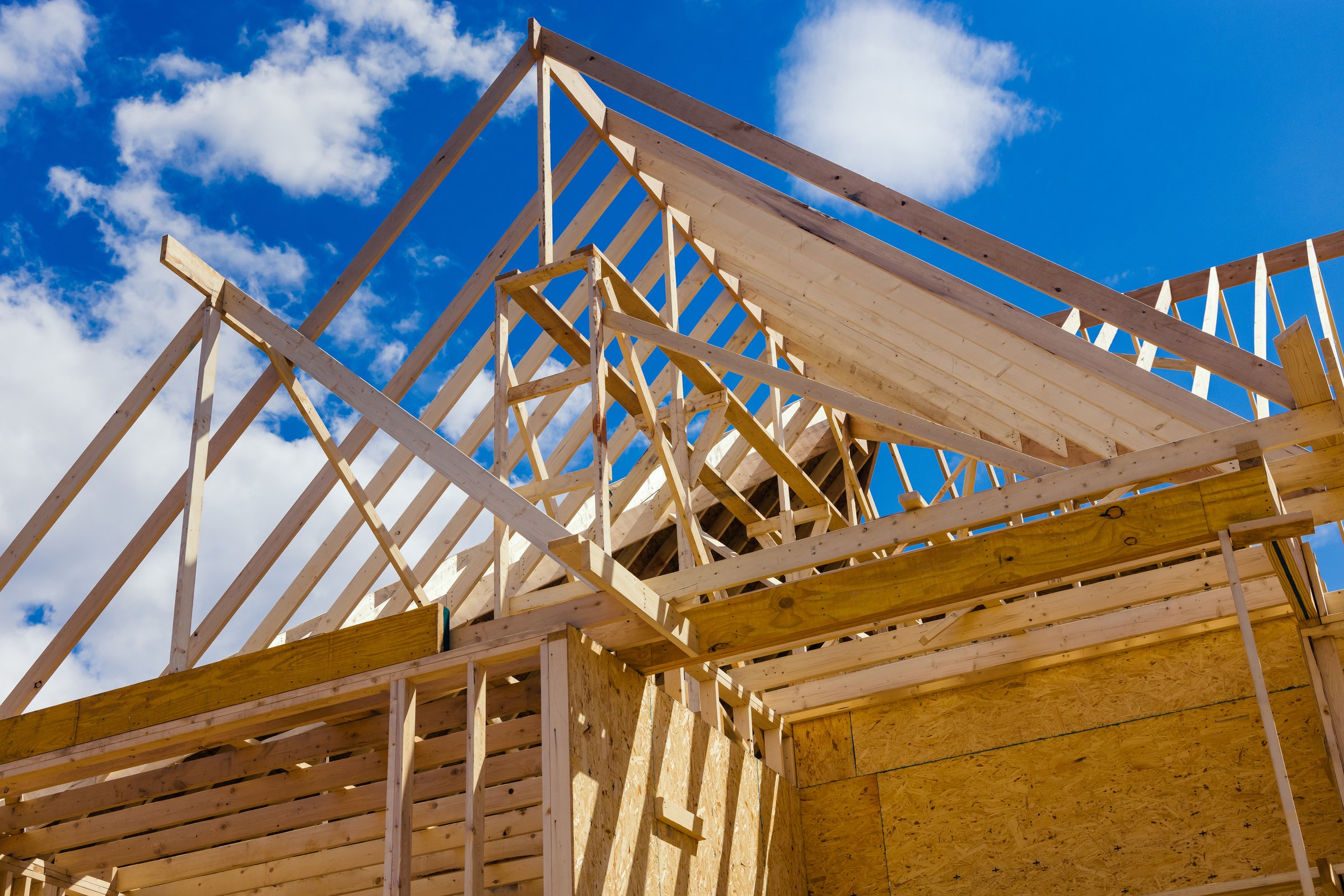 Wooden beams at construction the roof framing truss system house