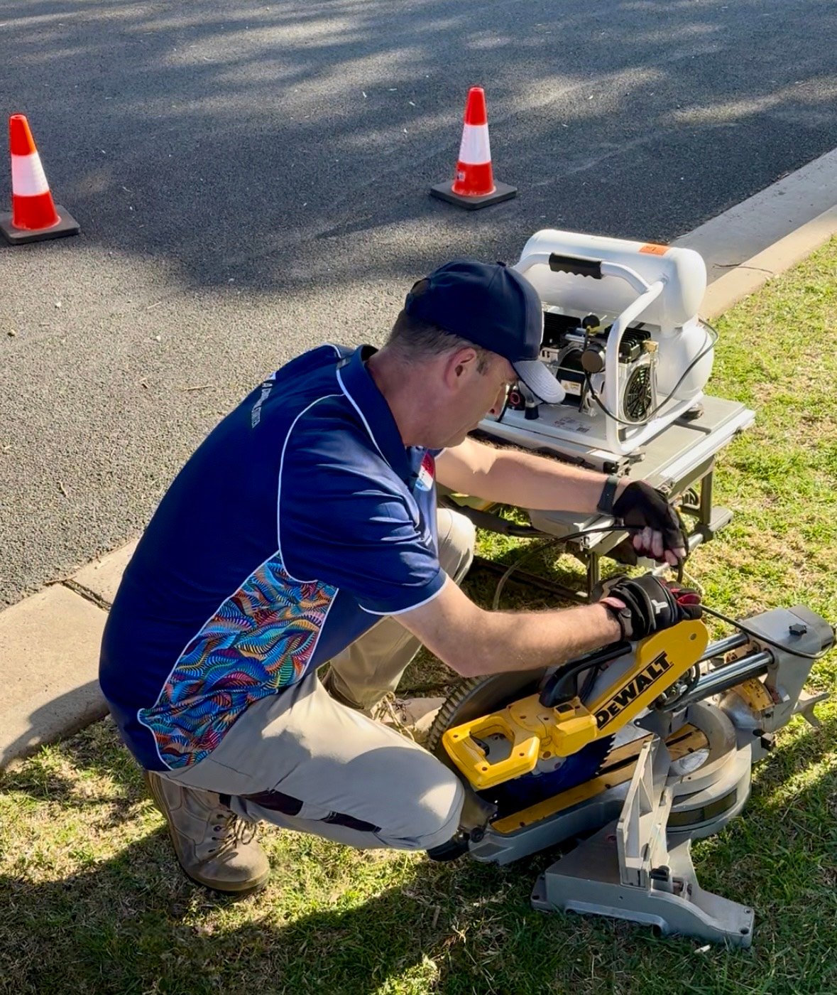 Liberty Test & Tag certified technician performing electrical safety testing on power tools with professional testing equipment