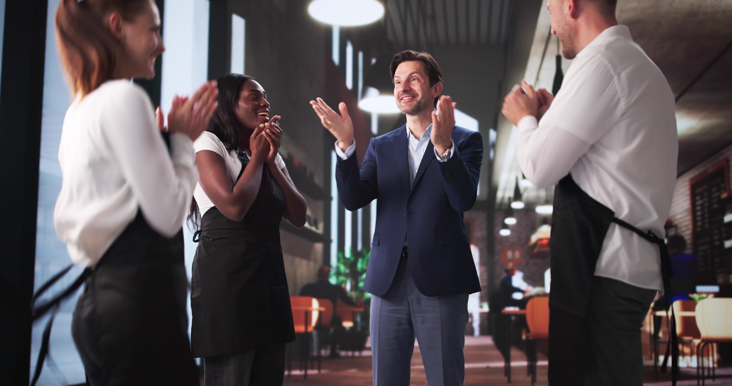 Excited Restaurant Manager Celebrating Success With Waiters And Waitresses
