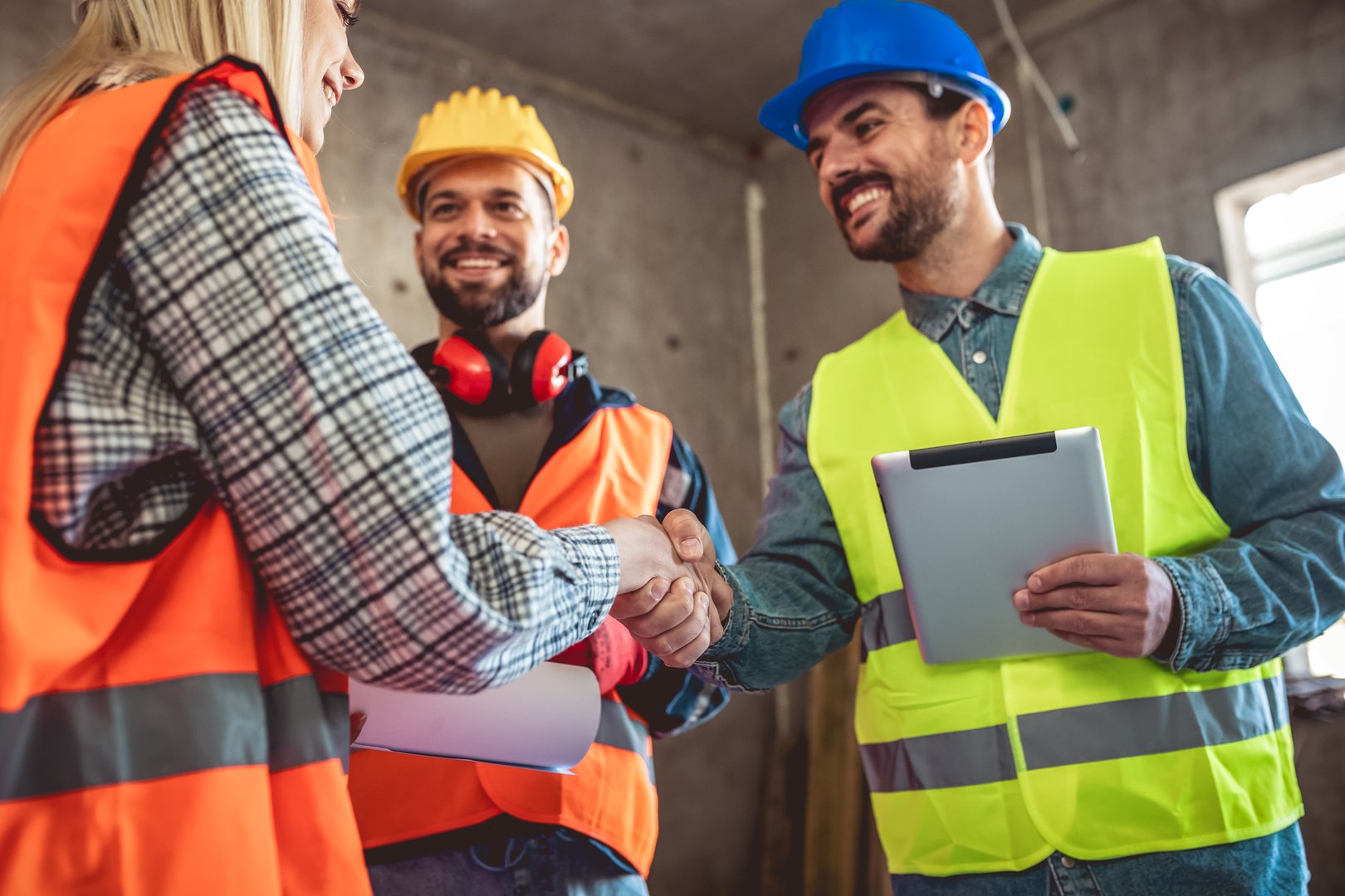Contractor.Construction worker team hands shaking after plan project contract  at construction site, contractor, engineering, partnership, construction concept