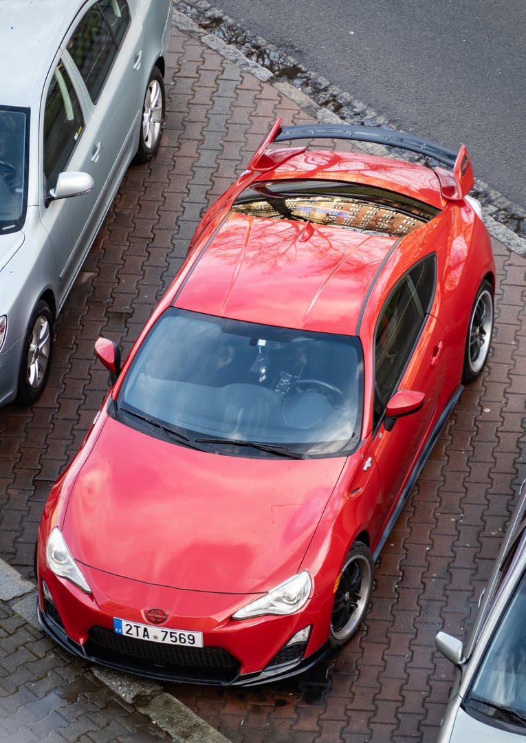 Ostrava, Czechia - February 4, 2024: Top front view of red Scion FR-S sports car known as Toyota GT86 or Subaru BRZ, parked on street