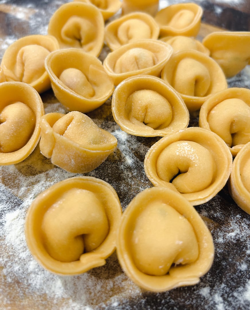 Multiple freshly made rustic handcrafted pasta tortellini