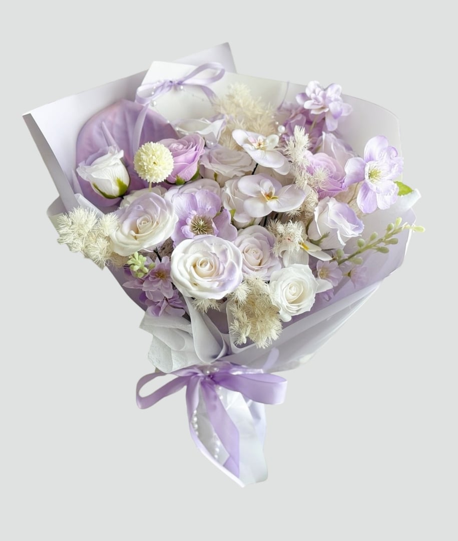 A magnificent and lavishly designed bouquet of fresh flowers, crafted with extraordinary care and attention to detail, where every delicate petal tells a story of elegance and beauty. This enchanting arrangement features a stunning combination of velvety red roses symbolizing passion and eternal love, soft pastel peonies radiating charm and tenderness, pure white lilies expressing purity and grace, and vibrant seasonal blooms that add a touch of freshness and joy, all perfectly complemented with lush green foliage that enhances the natural allure of the bouquet. Overflowing with fragrance, color, and emotion, this bouquet is not just a simple floral arrangement but a true masterpiece of nature and artistry, designed to illuminate any space, elevate every celebration, and create everlasting memories for weddings, anniversaries, birthdays, romantic surprises, or any occasion where words are not enough to express deep feelings of affection, gratitude, and admiration