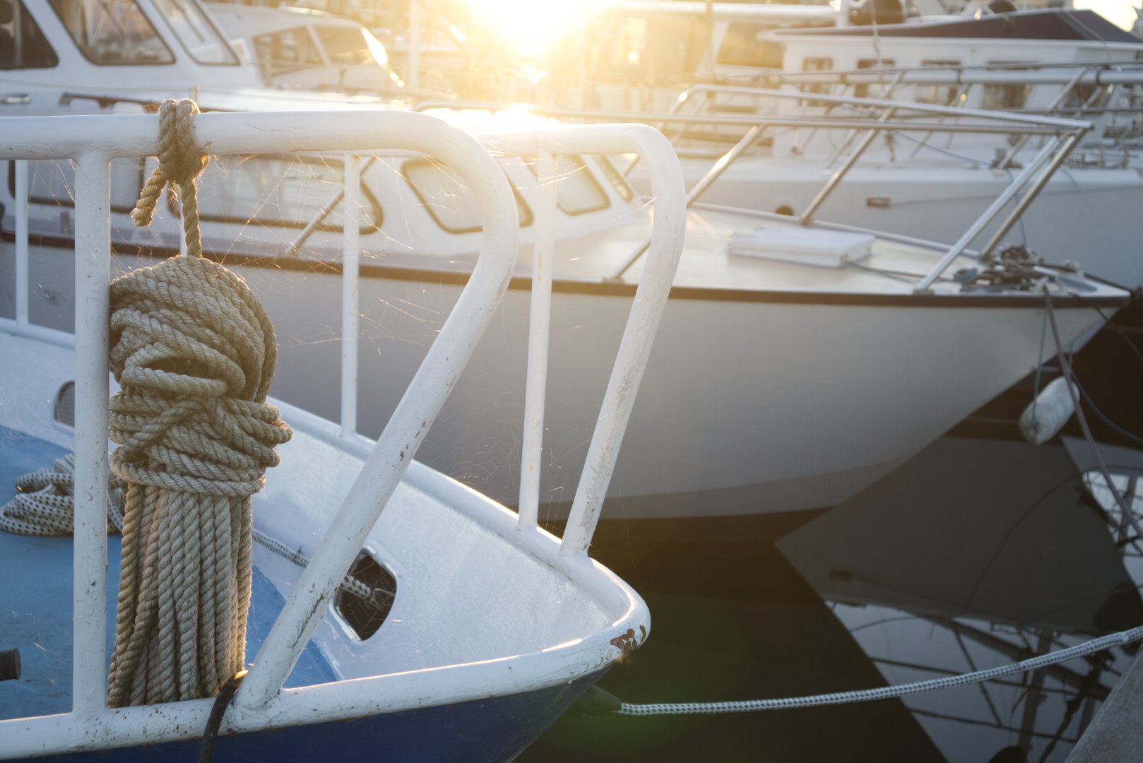 Close-up of Nautical Rope on a Moored Boat with Bright Sun Glare in Marina