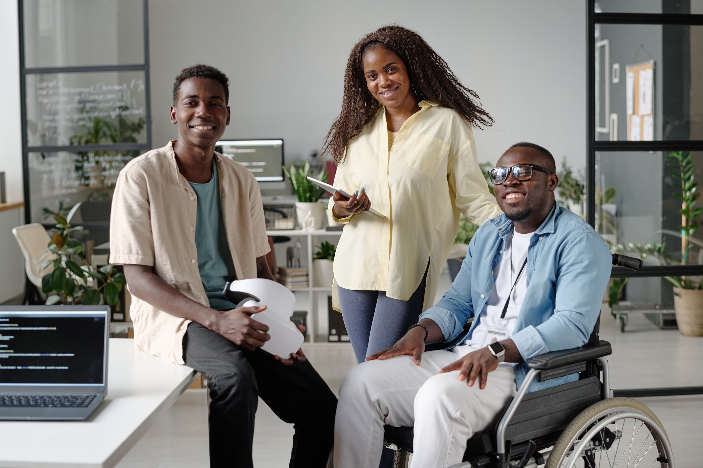 African American office workers posing for portrait together while they in office of IT company