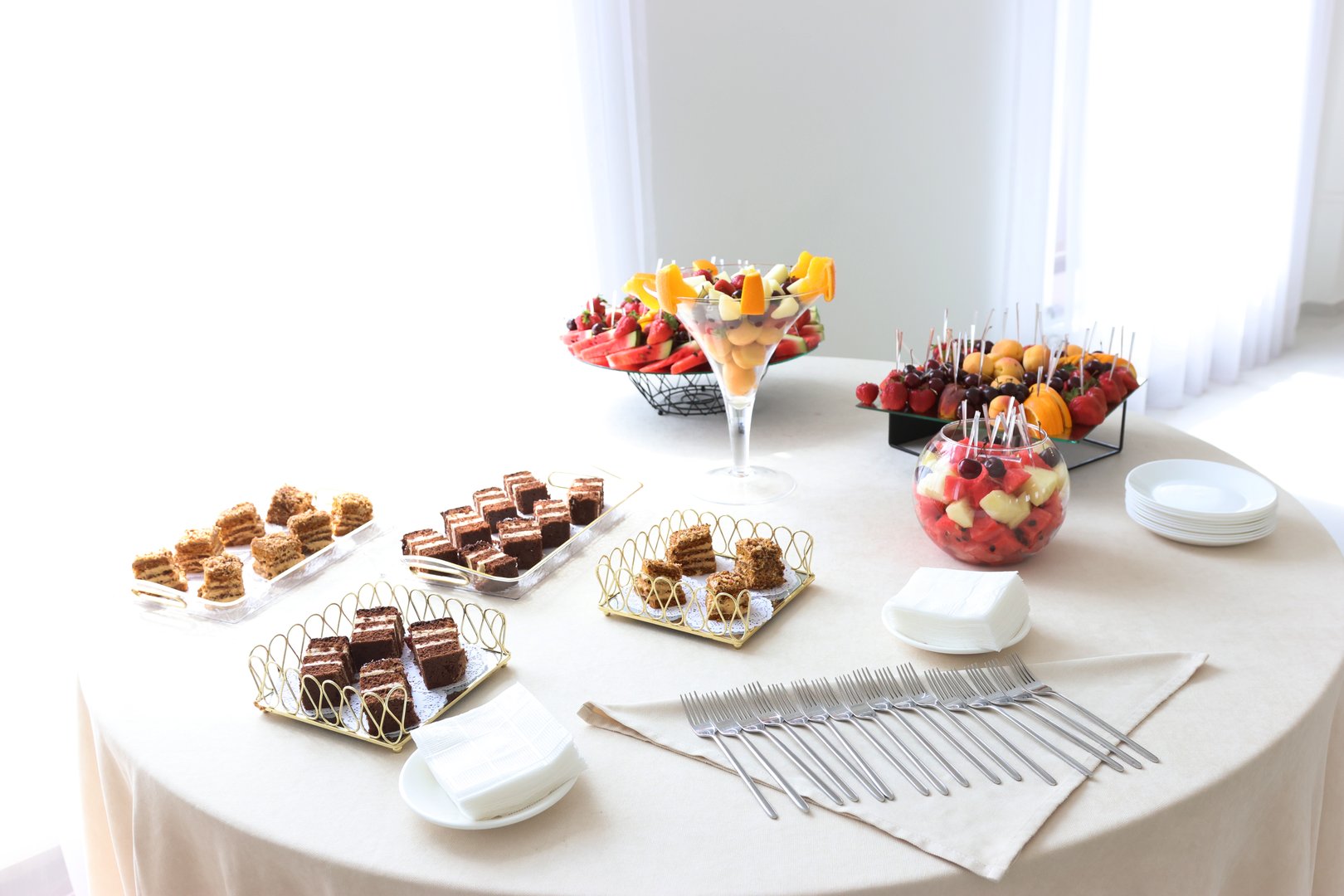 Sweet buffet table with cakes and pastries.