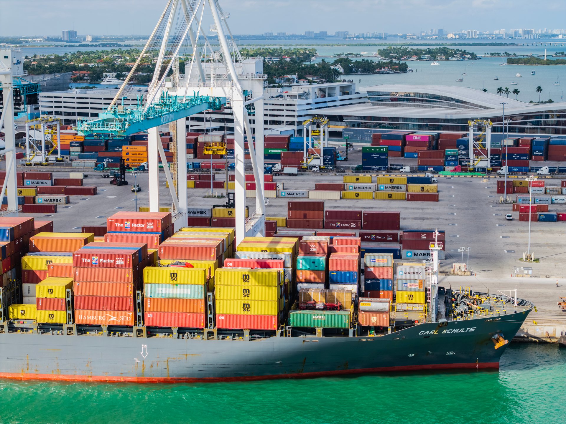 Miami, Florida - February 12, 2025: Export and import. Port of Miami. Cargo ship loaded with container in Miami, aerial. Freight container. Aerial Miami port with cargo container. Cargo handling.