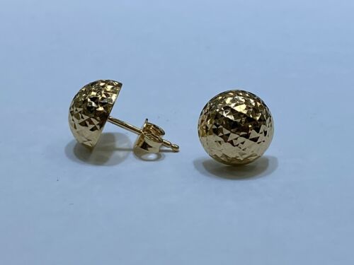 Two gold spherical stud earrings with a textured, faceted surface placed on a flat white surface.