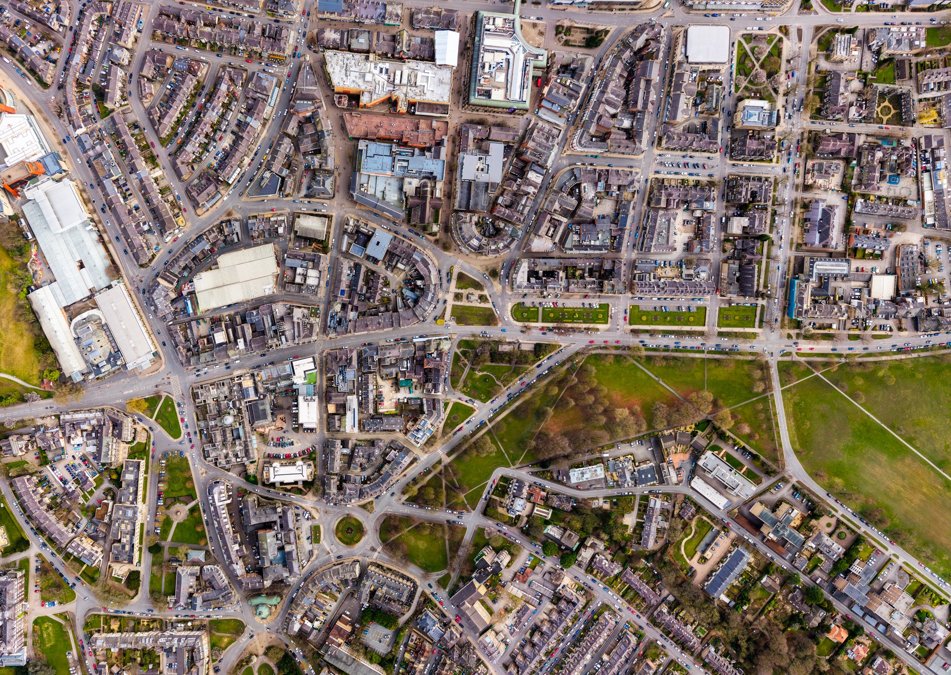 An aerial bird's eye view townscape directly above Harrogate town centre in North Yorkshire, UK with map style view including The Stray public park and retail district
