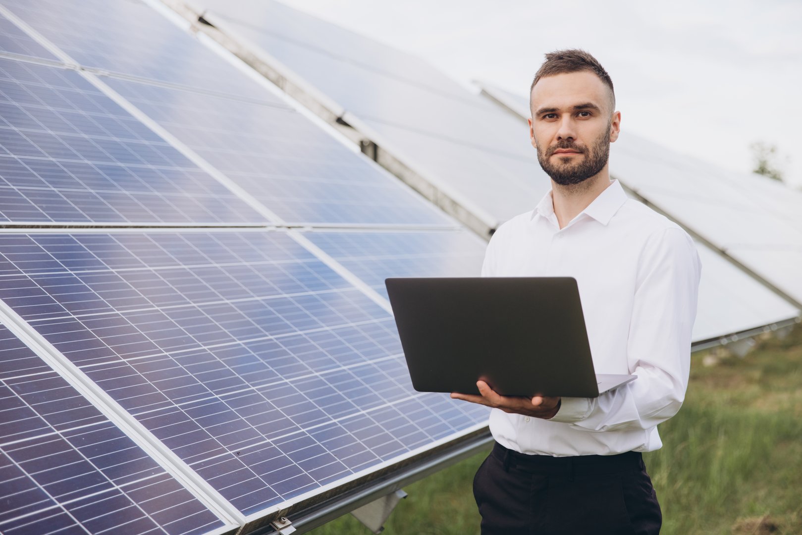 Technical engineer with laptop at solar power plant