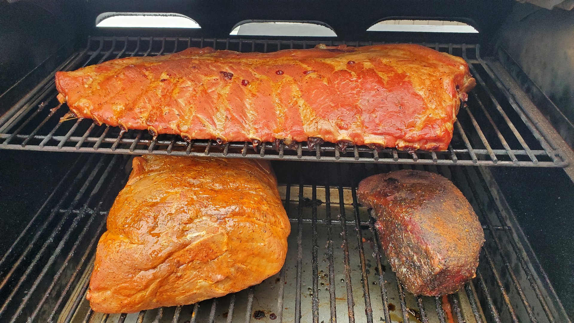 BBQ ribs, pork, and beef on the grill