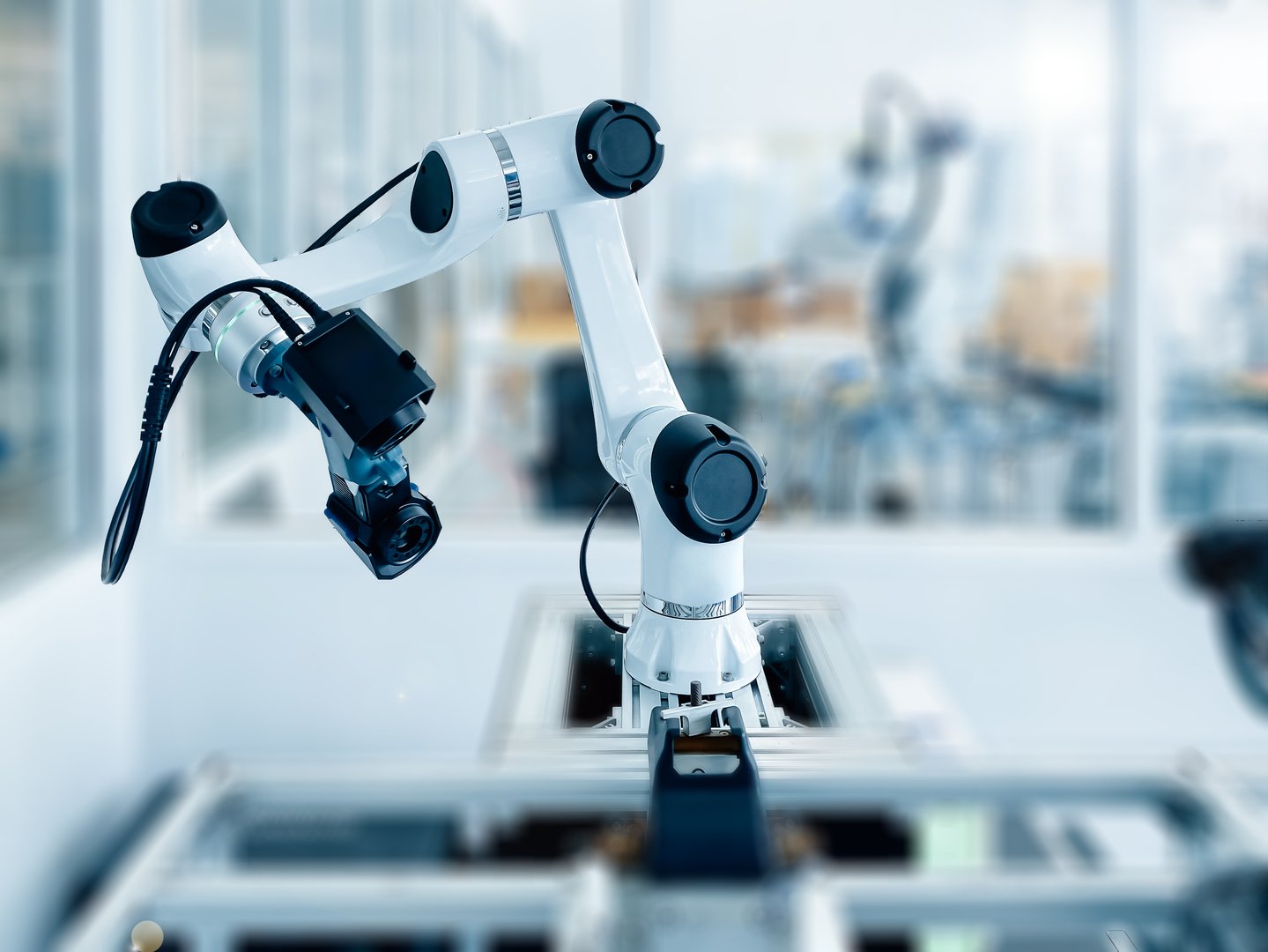 Robotic arm equipped with high-tech 3D scanner in an advanced manufacturing facility. Precision and automation in industrial technology.