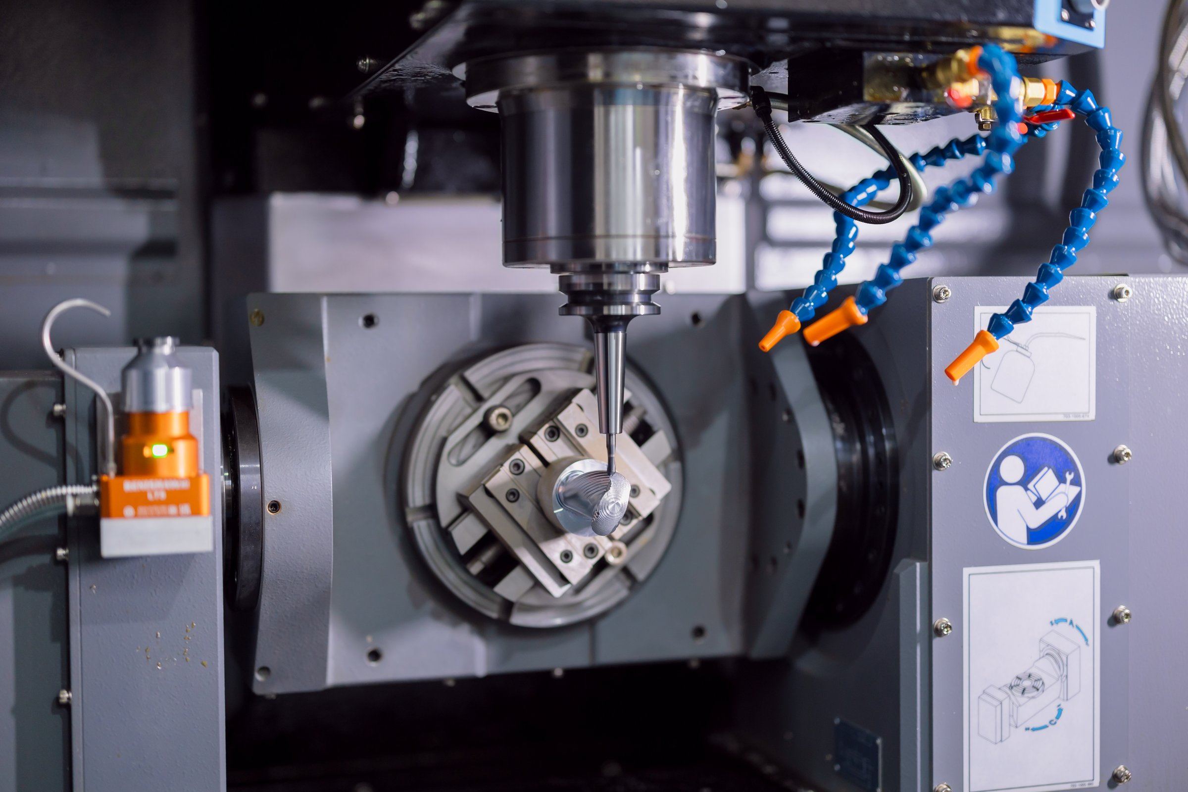 Modern 5 Axis CNC advance metal Milling Machine working in heavy industry factory. Drilling machine on working process in workshop