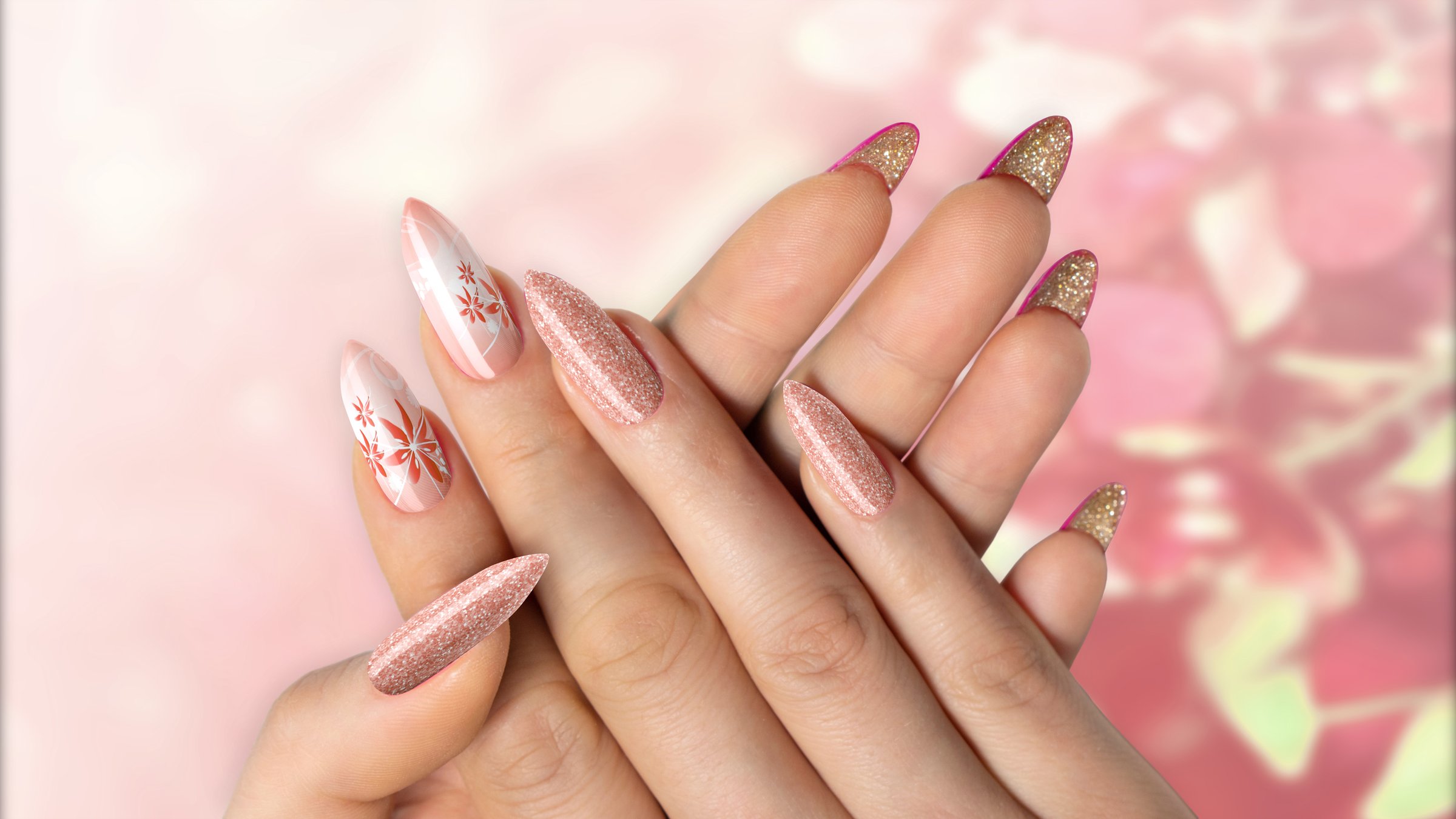 Female hands with flower nail design. Brown nail polish manicure on flower background.