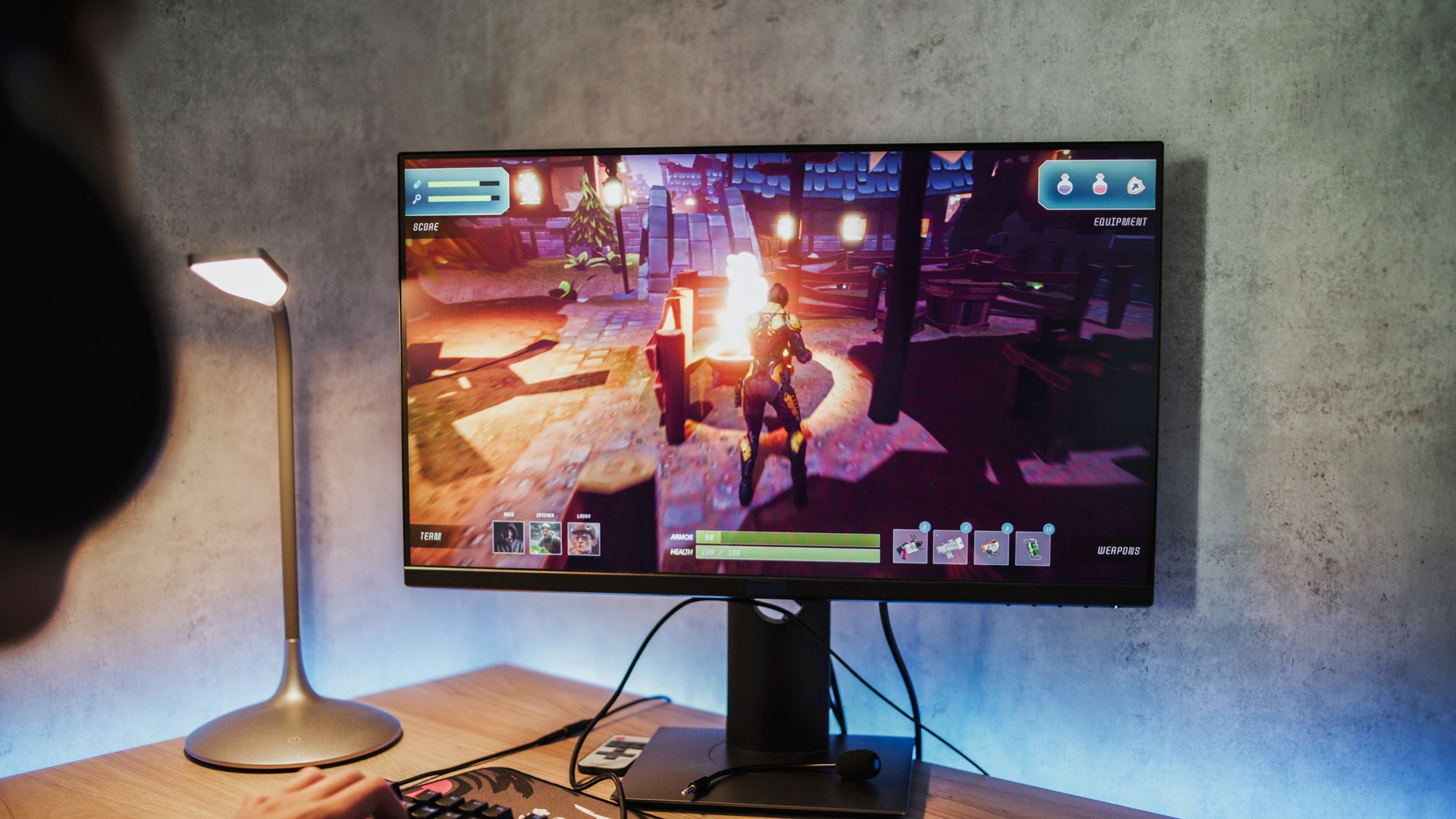 Professional young gamer wearing headphones plays online video game on computer. Caucasian teen boy spends leisure time at home, enjoys gameplay in 3D third person shooter on PC. Gaming and eSports.