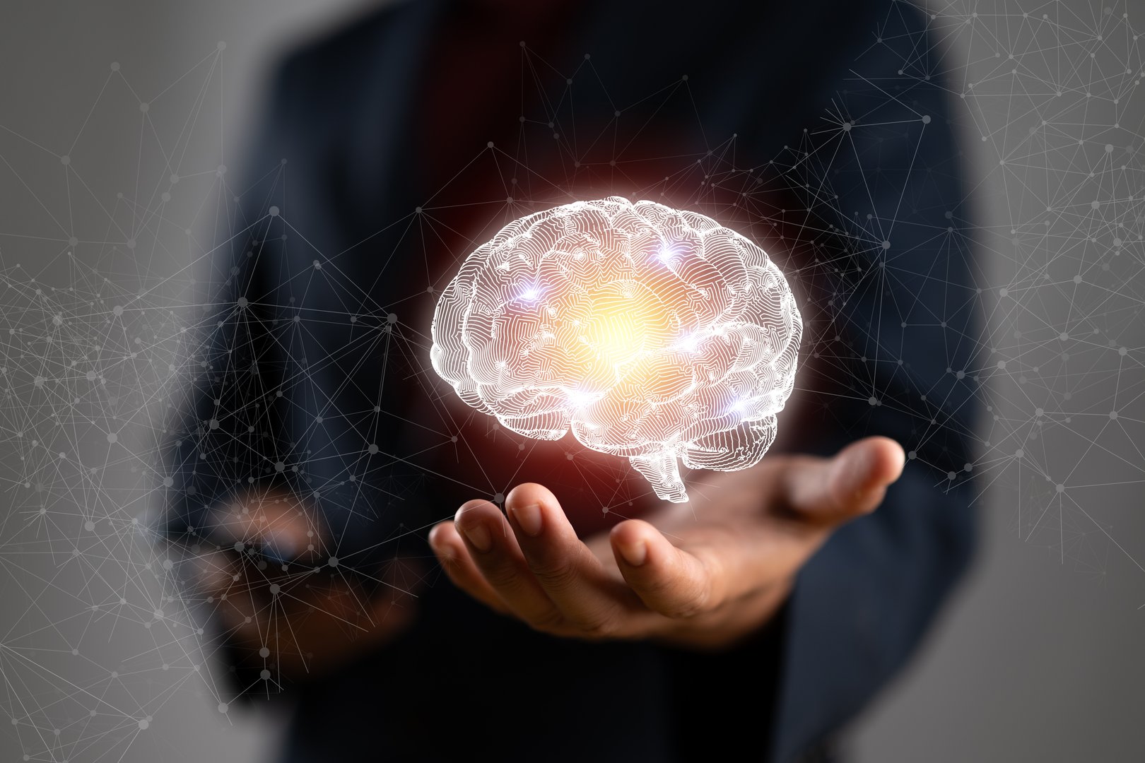 Businessman holding human brain and icon customer digital network with effective business mindset on paper texture background