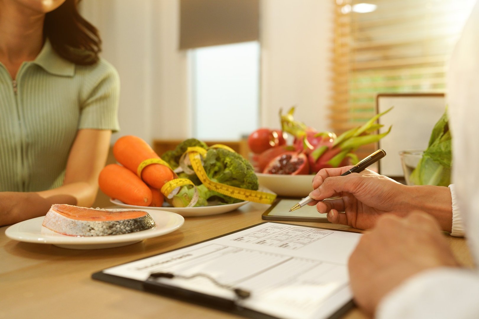 Dietician, male nutrition specialist consulting woman, developing healthy diet, dietary program. Dietary consultant asking, giving male patient advice, help, nutritional information, new meal plan.