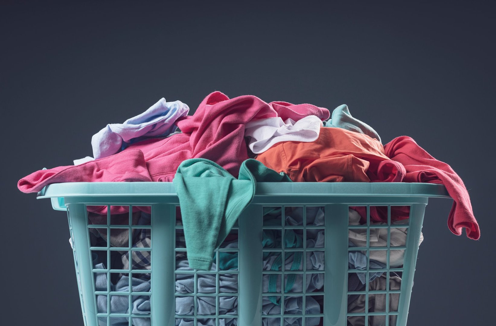 Full laundry basket with clean clothes, blank copy space