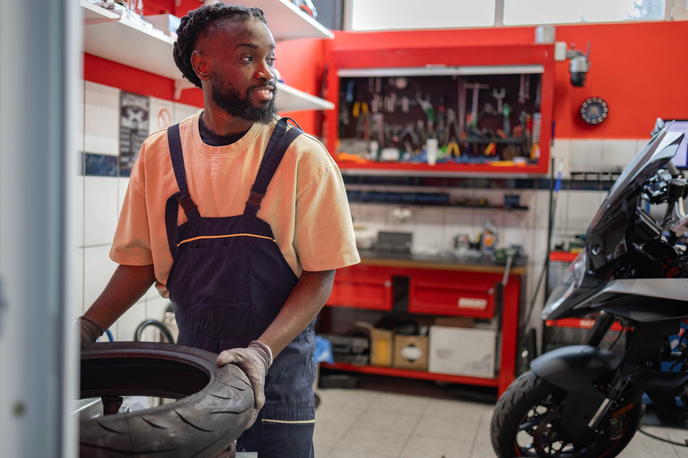 Worker changing a motorcycle tire