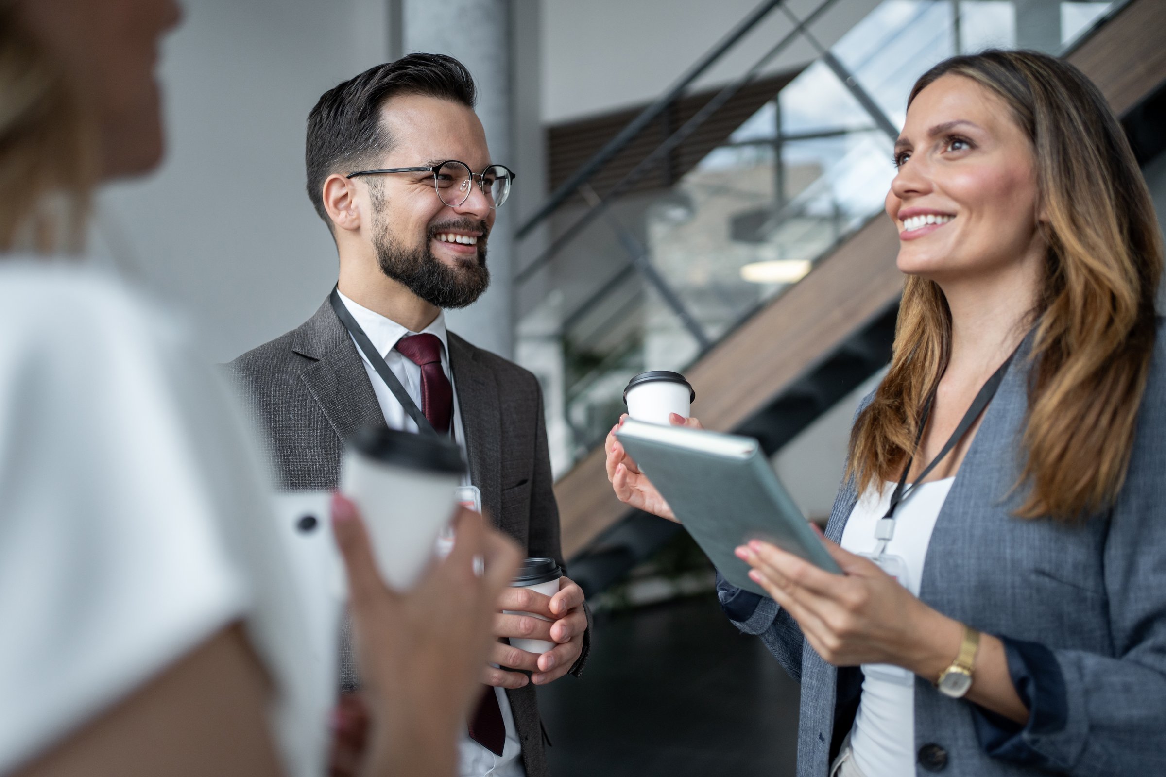 Business colleagues enjoying a coffee break, engaging in lively discussions and exchanging innovative ideas during a conference, enhancing teamwork and fostering collaboration
