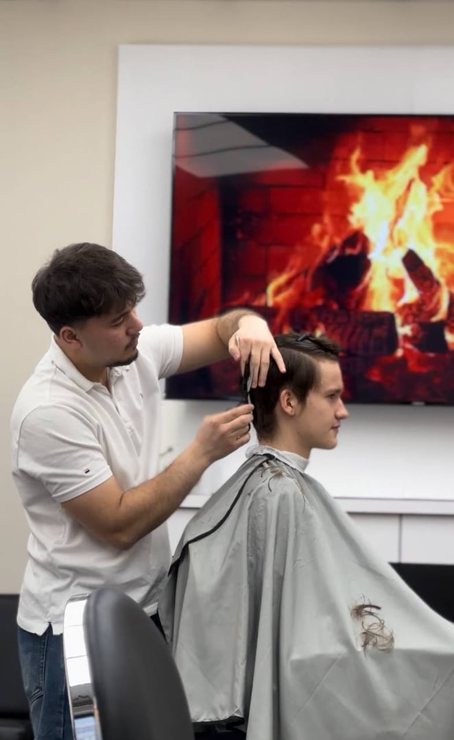 Yasin - Professional Barber at Level Barbershop giving precision haircut