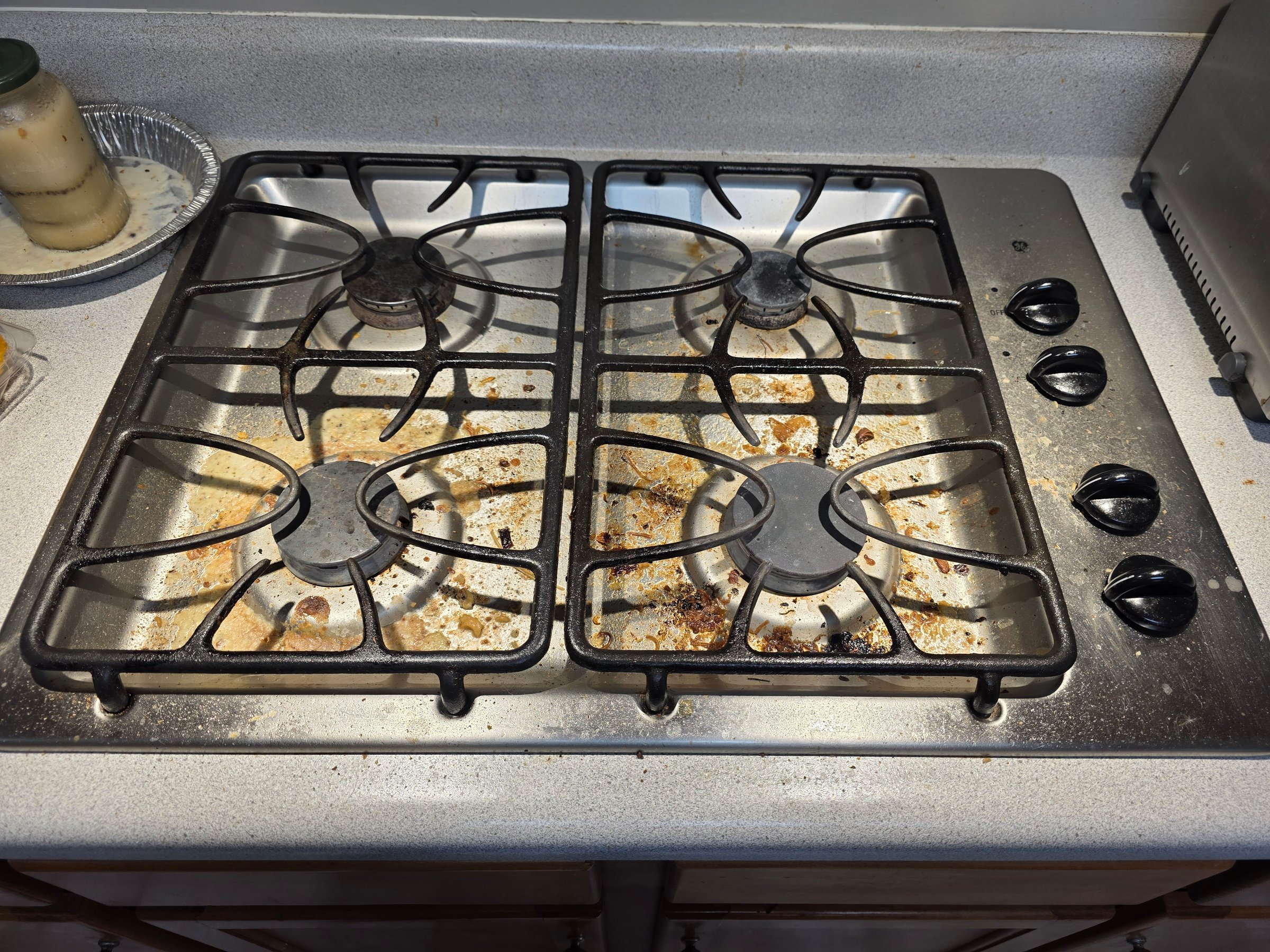 Kitchen before cleaning - showing dirty and cluttered state