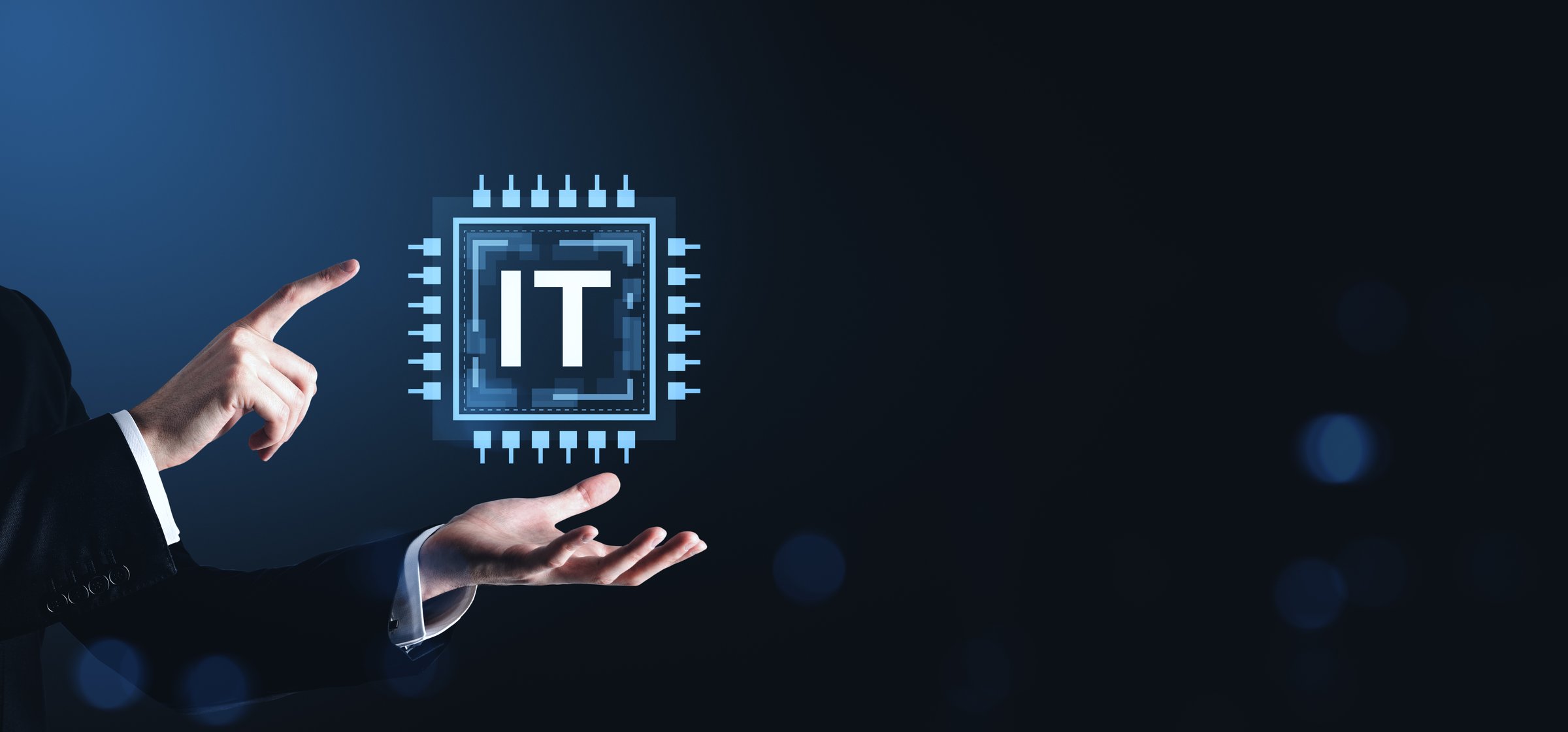 Businessman pointing at glowing IT chip graphic, modern digital style, with dark gradient tech background, symbolizing innovation and technology